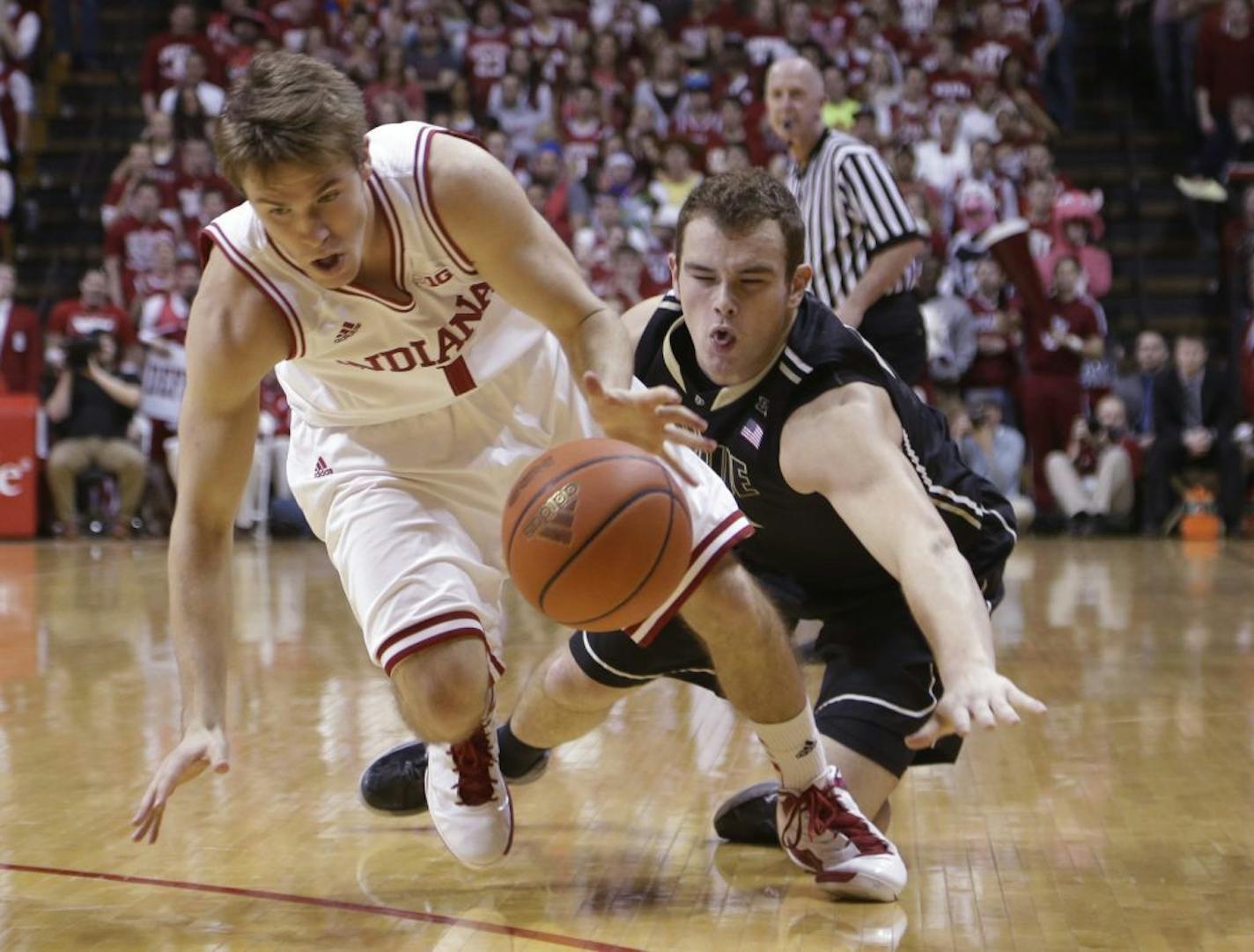 Indiana guard Jordan Hulls, left, and Purdue guard D.J. Byrd go for a loose ball in the first half.