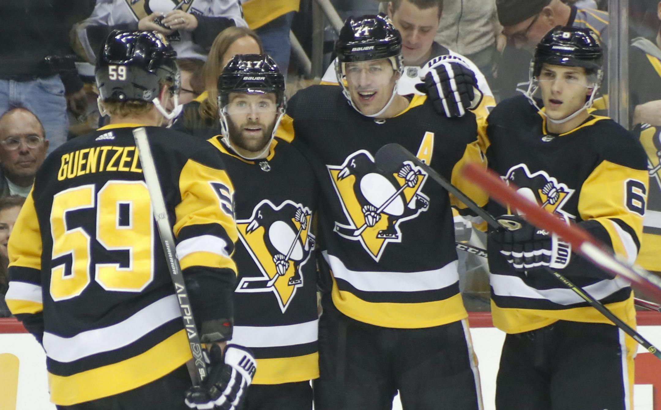 Pittsburgh Penguins' Evgeni Malkin (71) celebrates with teammates during the second period after scoring his second goal of an NHL hockey game against the Ottawa Senators, Monday, Dec. 30, 2019, in Pittsburgh. (AP Photo/Keith Srakocic)