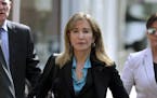 FILE - This April 3, 2019 file photo shows actress Felicity Huffman arriving at federal court in Boston to face charges in a nationwide college admiss