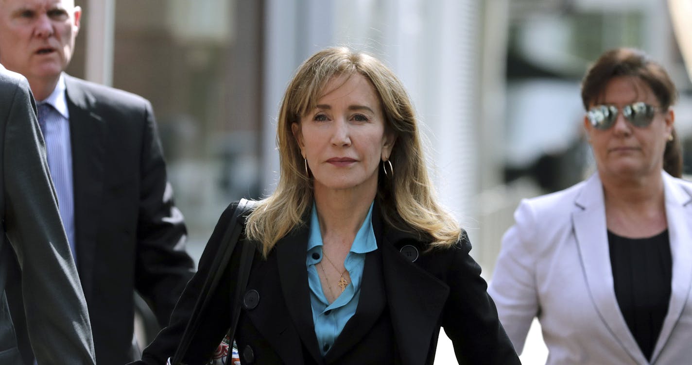 FILE - This April 3, 2019 file photo shows actress Felicity Huffman arriving at federal court in Boston to face charges in a nationwide college admissions bribery scandal. Huffman is facing a prison sentence after agreeing Monday to plead guilty to one count of conspiracy and fraud for paying a consultant $15,000 disguised as a charitable donation to boost her daughter&#x2019;s SAT score. Prosecutors are seeking four to 10 months of confinement, and experts different on whether the plea, and Huf