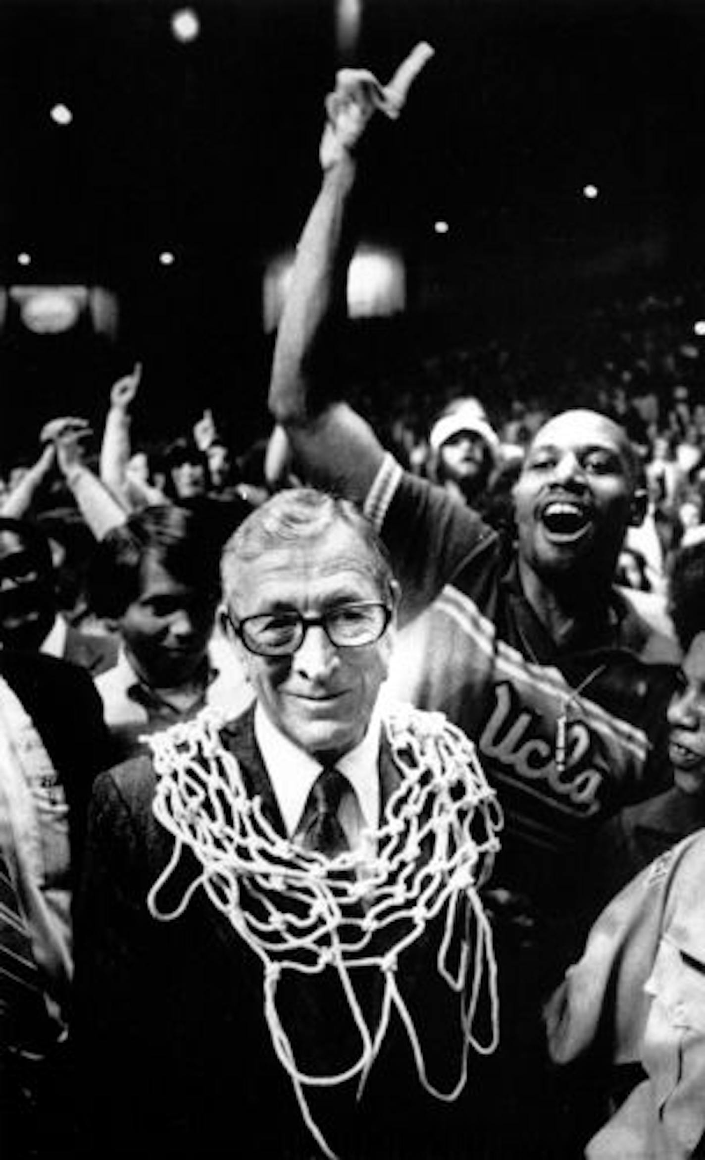 UCLA basketball coach John Wooden wore a basketball net as a necklace after the Bruins won the NCAA basketball championship over Kentucky 92-85 in 1975. It was Wooden's 10th and final national title. Wooden died Friday at age 99.