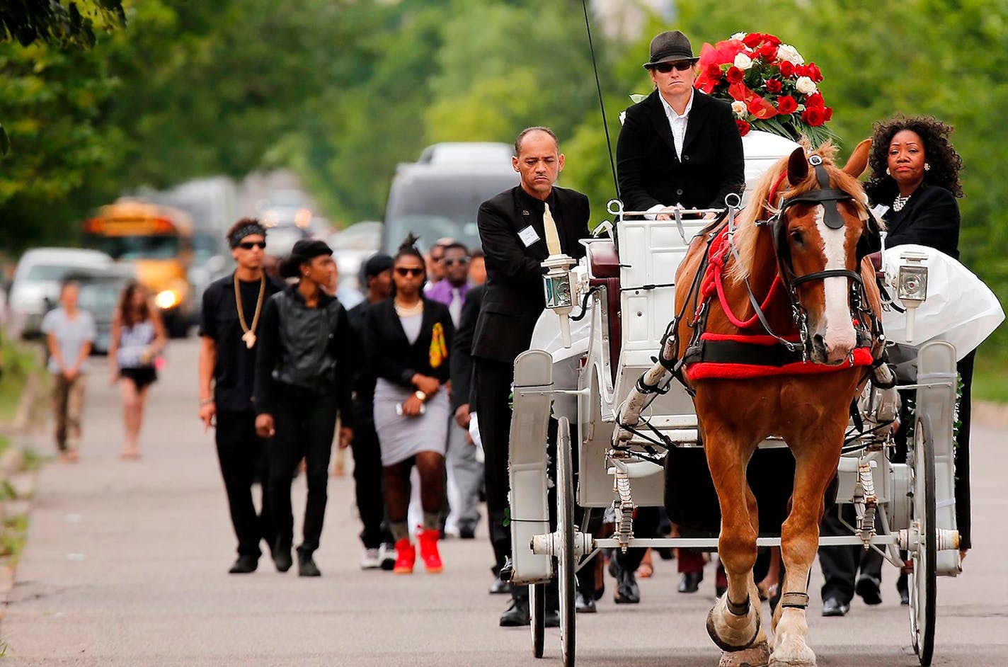 The funeral procession for Philando Castile moves along Concordia Avenue this morning in St. Paul.