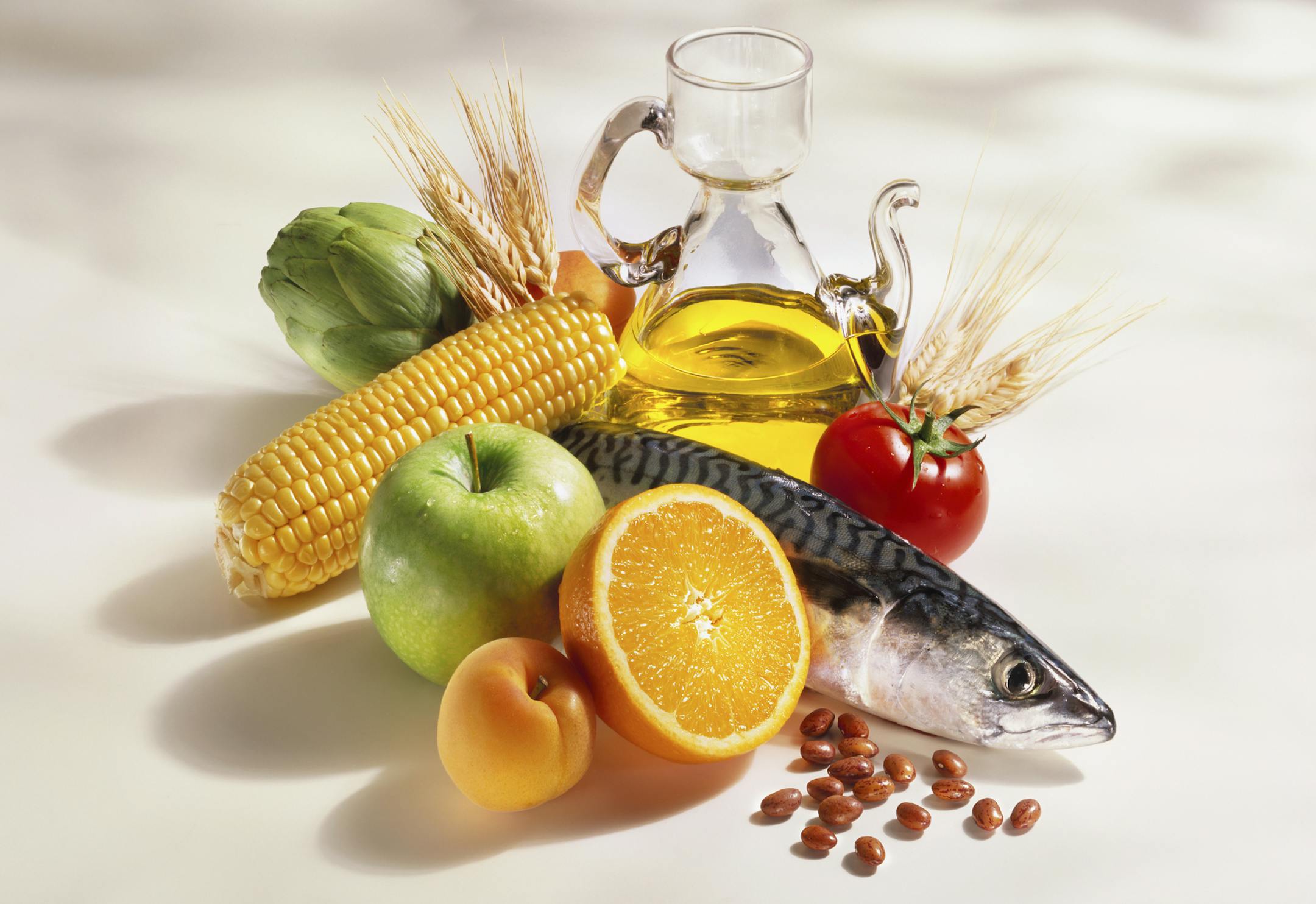A beautiful group of products, (Fish, fruit, vegetables, cereals, beans, and olive oil) typical in the mediterranean diet