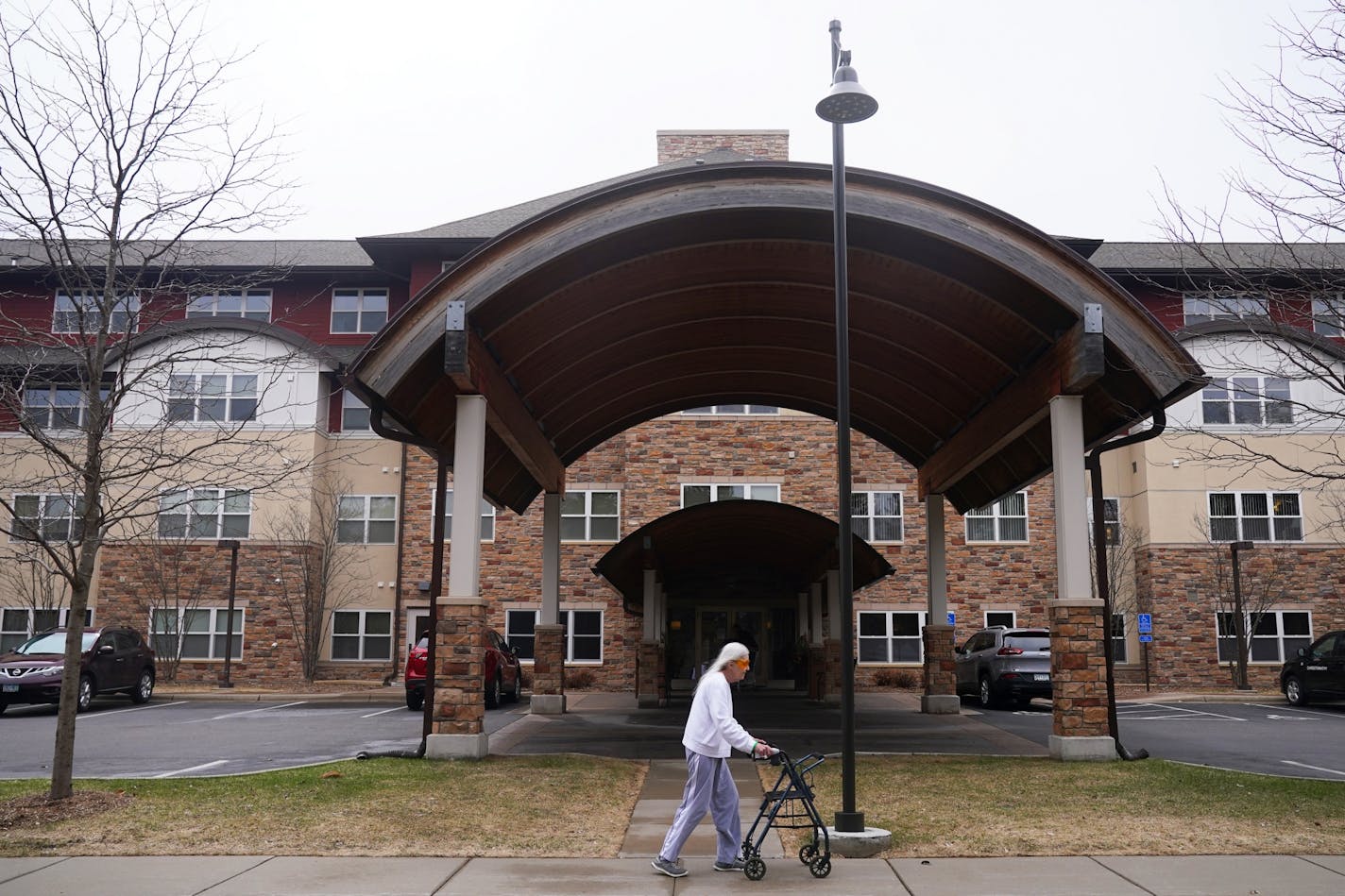 A woman walked past The Glenn Minnetonka, one of four dozen facilities statewide reporting outbreaks of the Coronavirus.