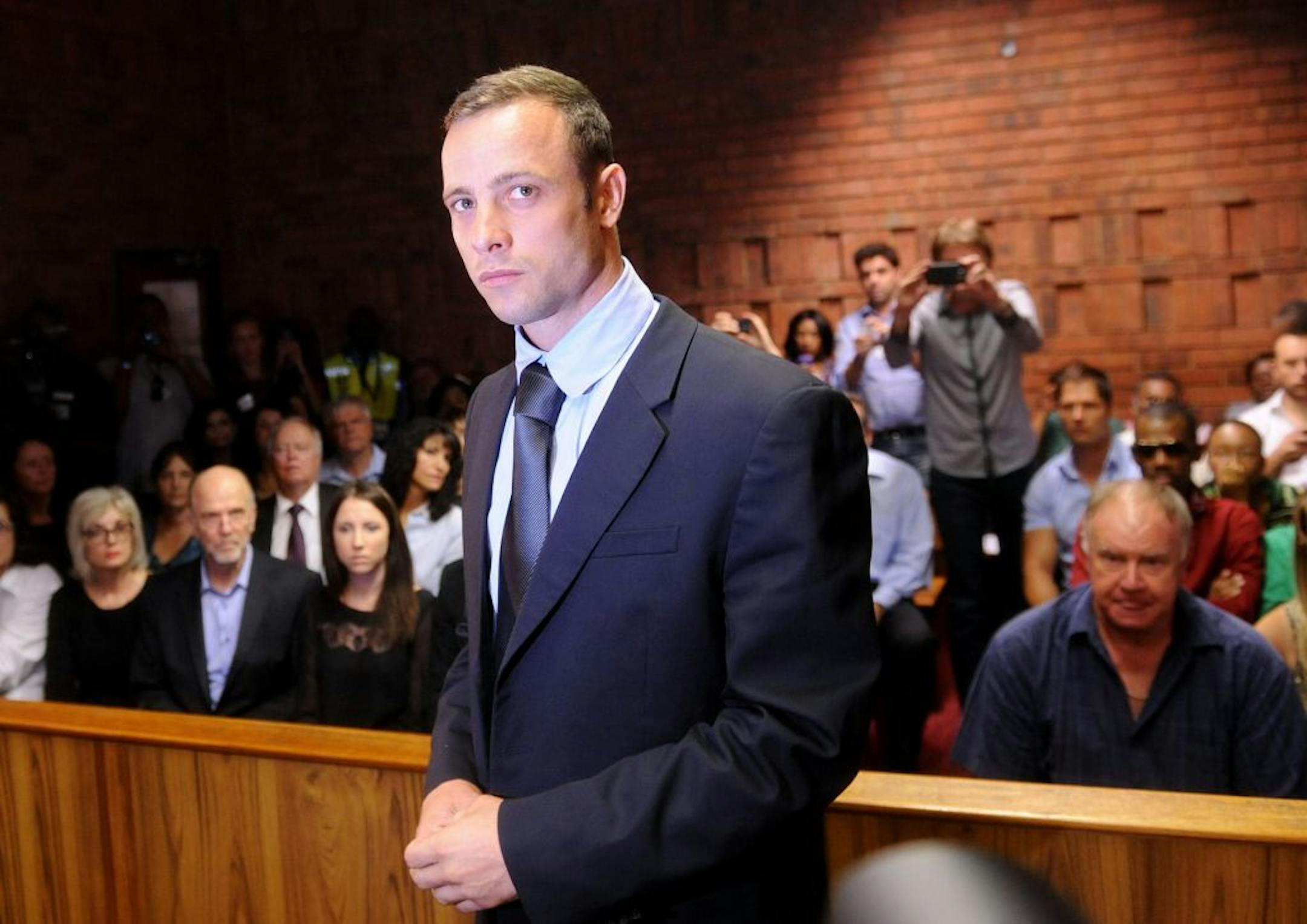 Oscar Pistorius is settling a three-year-old case against a former neighbor over reputation damages in a dispute that has now been overshadowed by the murder charges the Olympic star faces in the Valentine's Day shooting of his girlfriend.