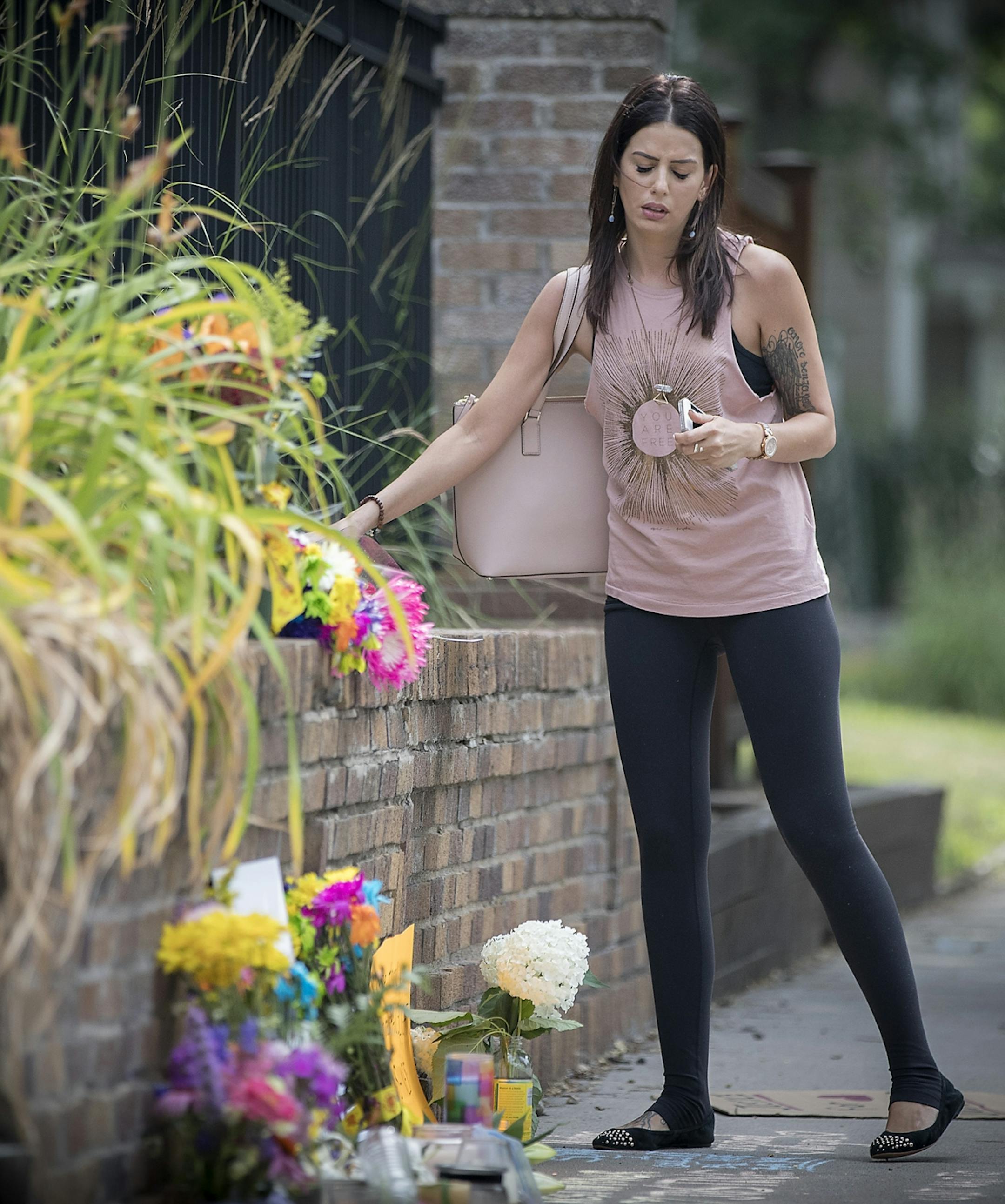 Friends and community members left flowers at a makeshift memorial at the scene where a Minneapolis police officer shot and killed Justine Damond, Monday, July 17, 2017 in Minneapolis, MN.