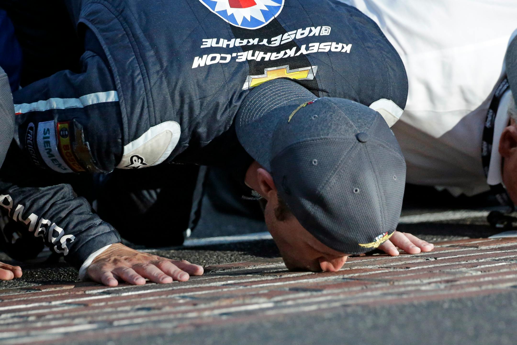 Kasey Kahne kisses the yard of bricks on the start/finish line after winning last year's Brickyard 400. He will not race in this year's event.