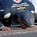 Kasey Kahne kisses the yard of bricks on the start/finish line after winning last year's Brickyard 400. He will not race in this year's event.