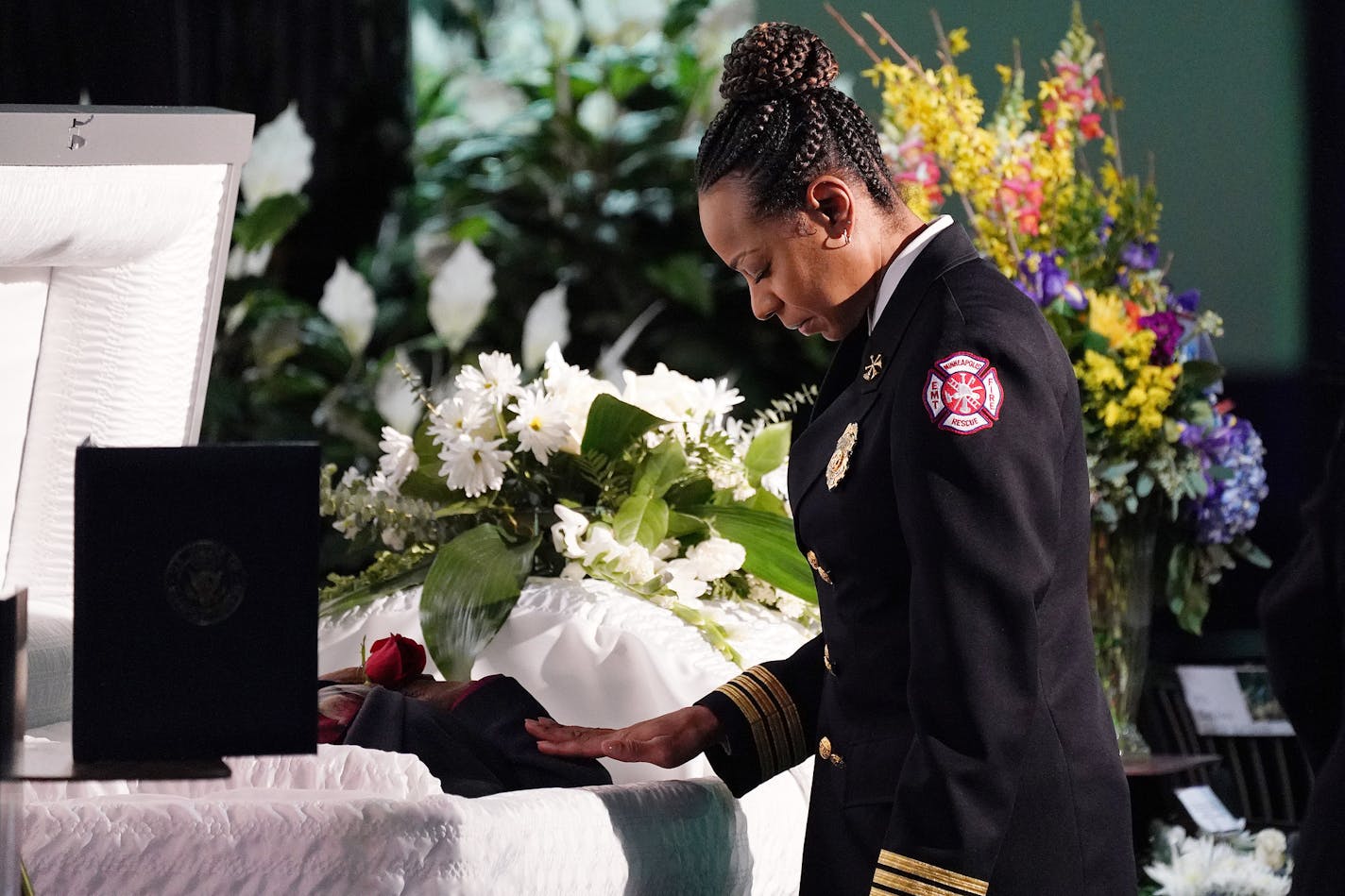 Melanie Rucker, a deputy chief with the Minneapolis Fire Department, stopped at the casket of Ron Edwards to pay her resects during his funeral service Saturday. Edwards was instrumental in the desegregation of the Minneapolis Fire Department as mentioned later in the program by Minneapolis Mayor Jacob Frey as he proclaimed Saturday Ron Edwards Day in the city. "He's always been a big advocate of the Minneapolis Fire Department and he's someone who paved the way for me," said Rucker noting that