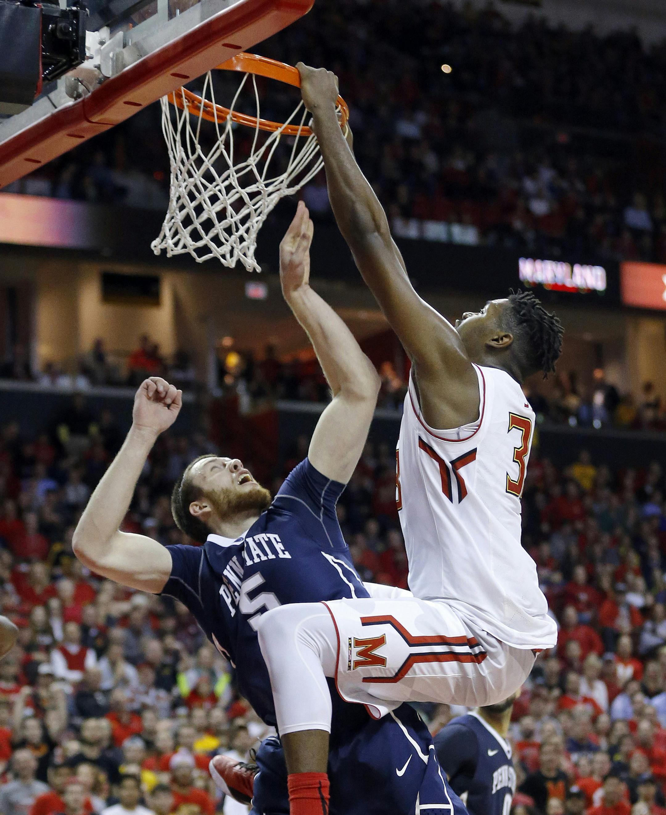 Penn State forward Donovon Jack, left, gets tangled with Maryland center Diamond Stone as Stone scores during the second half of an NCAA college basketball game, Wednesday, Dec. 30, 2015, in College Park, Md. Jack received a goaltending call on the play. Stone contributed a game-high 39 points to Maryland's 70-64 win. (AP Photo/Patrick Semansky)