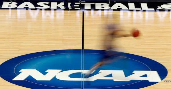 FILE - In this March 14, 2012, file photo, a player runs across the NCAA logo during practice in Pittsburgh. The NCAA is moving closer to permitting D