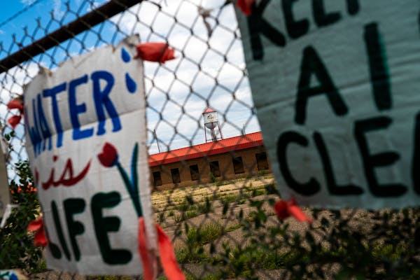 Protest signs are tied on the fence of the former Roof Depot site during a rally in East Philips in support of an urban farm on Sunday, August 1, 2021
