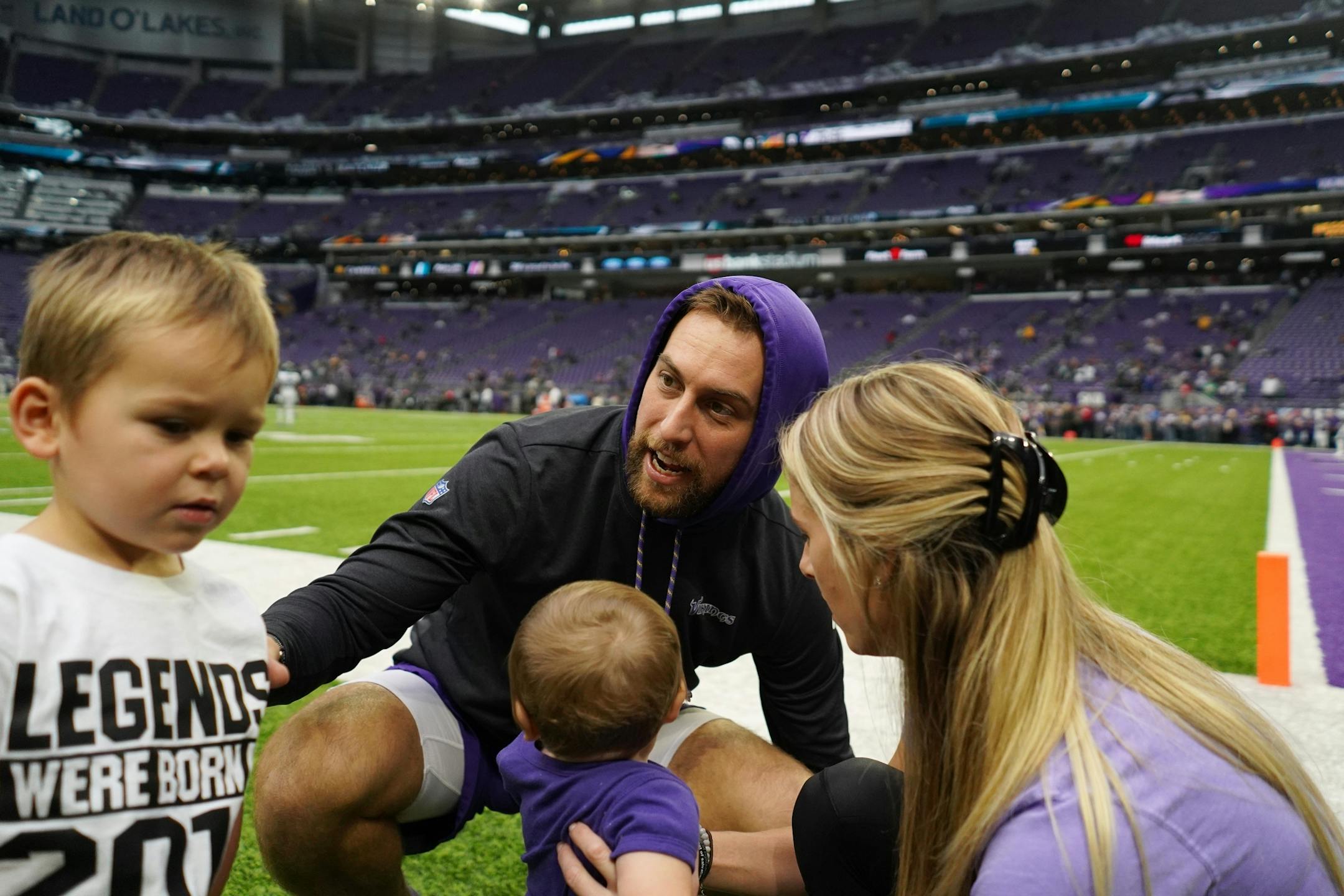 Minnesota Vikings wide receiver Adam Thielen (19) greets his wife Caitlin and their two sons Asher, left, and Hudson, ahead of Sunday's game against the Philadelphia Eagles.