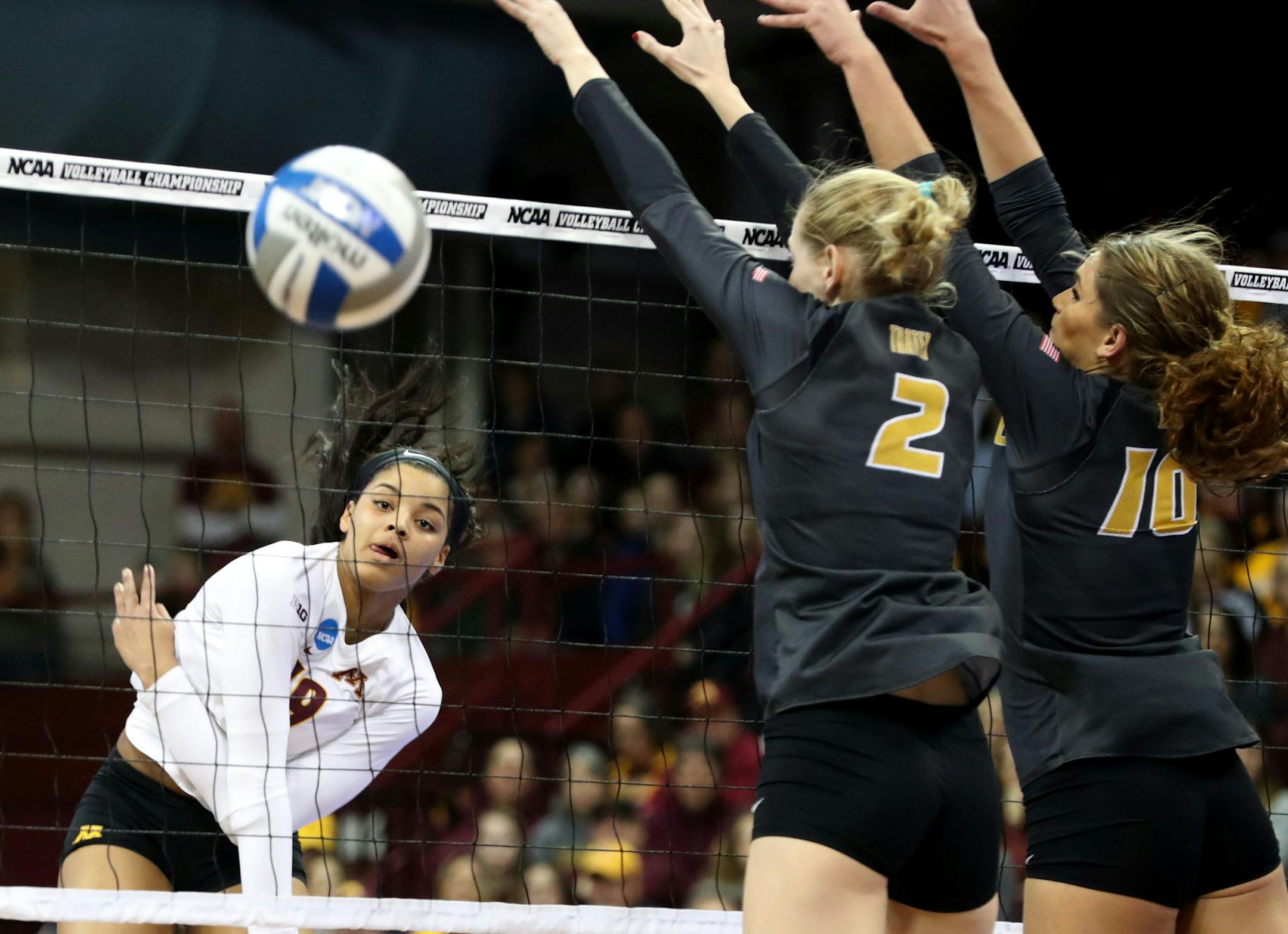 The University of Minnesota&#x2019;s Alexis Hart (19) spikes a shot over the University of Missouri&#x2019;s Emily Thater (2) and Kira Larson (10)