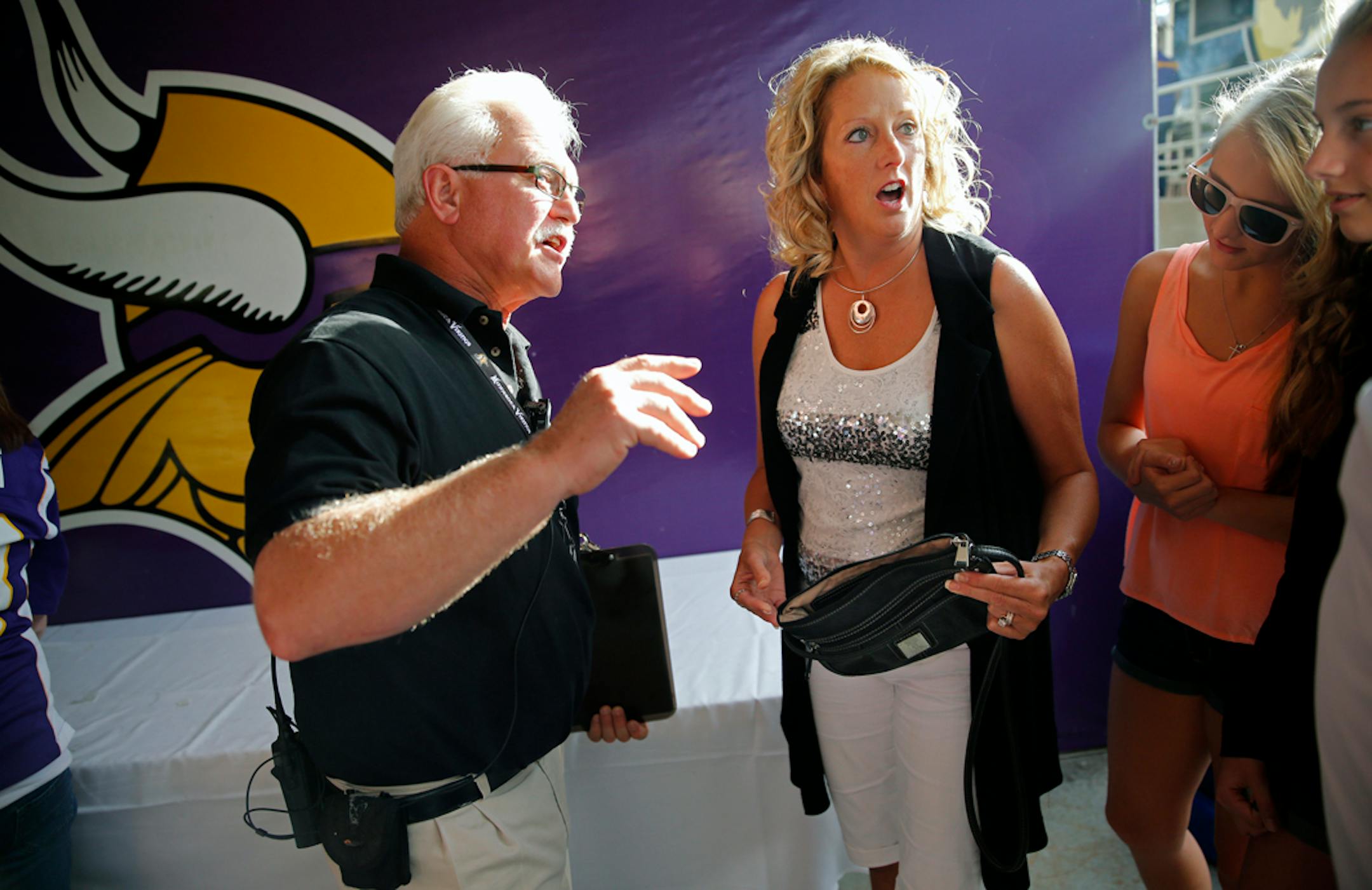 At the Metrodome, the NFL has instituted that non-clear bags larger than 4.5" by 6.5" cannot be brought into the stadium. Left to right, security supervisor Steve Smith told a very frustrated Jody Volk of Mankato that her purse way too big too bring inside. "Who is going to carry a clear plastic bag with feminine products?," said Volk who was with daughters Lexi and Alix.] tsong-taataarii@startribune.com