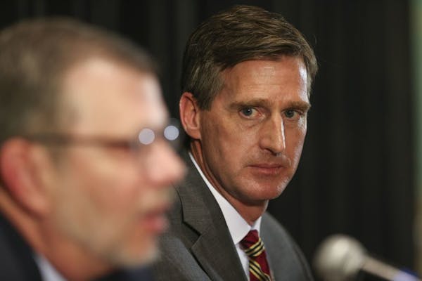 Mark Coyle, shown with University of Minnesota President Eric Kaler, was introduced as the Gophers' new top athletic official at a news conference Wed