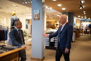 Longtime customer Kevin Cashman offered condolences on the closing of Hubert White to head tailor Dinh Nguyen, left, as Nguyen updated Cashman on the 