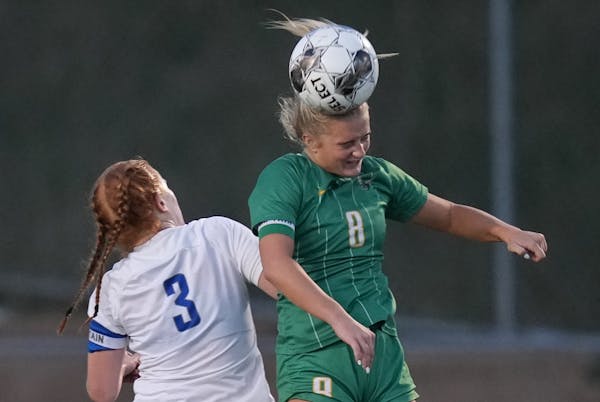 Edina’s Grace Pohlidal headed the ball against Minnetonka’s Darby Allen in the section final, won by Edina in overtime.