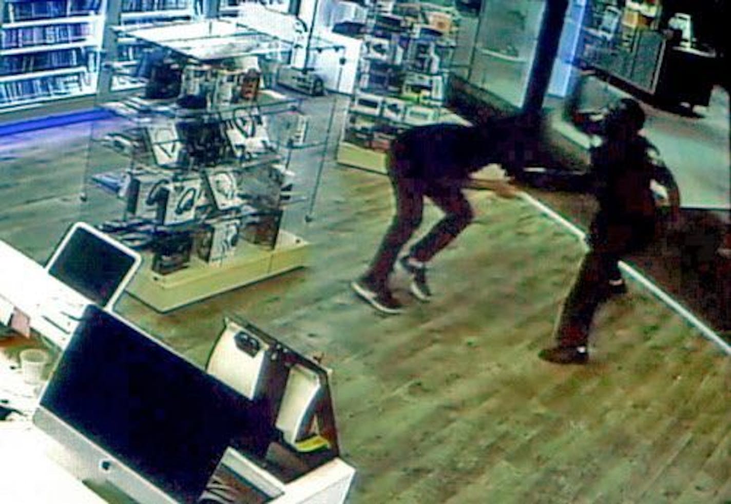 Frame grab from surveillance video of the St. Cloud mall attack shows Dahir Adan, right, attacking a mall worker with a knife at the beginning of his rampage.