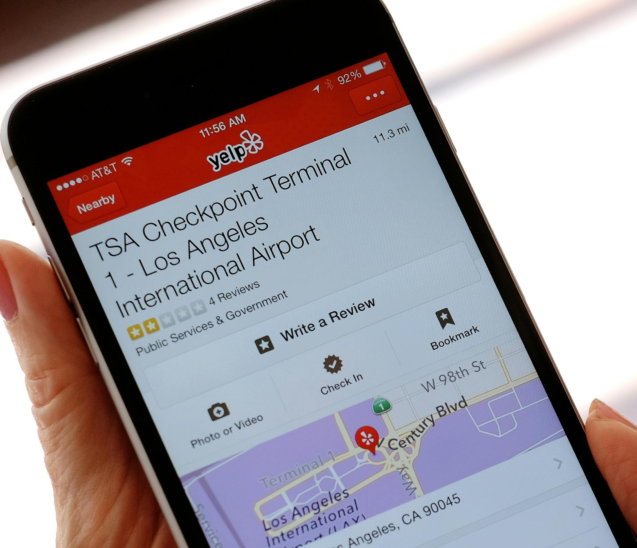The mobile view of the Yelp site application shown on an iPhone mobile, shows the TSA Checkpoint Terminal 1 at the Los Angeles International Terminal location in Los Angeles on Tuesday, Aug. 18, 2015. Frustrated travelers have already been turning to the popular site for years to vent about the long, slow-moving airport security lines, intrusive body scans and questioning of agents. The General Service Administration unveiled last week that it had reached a deal with Yelp so the public can rate