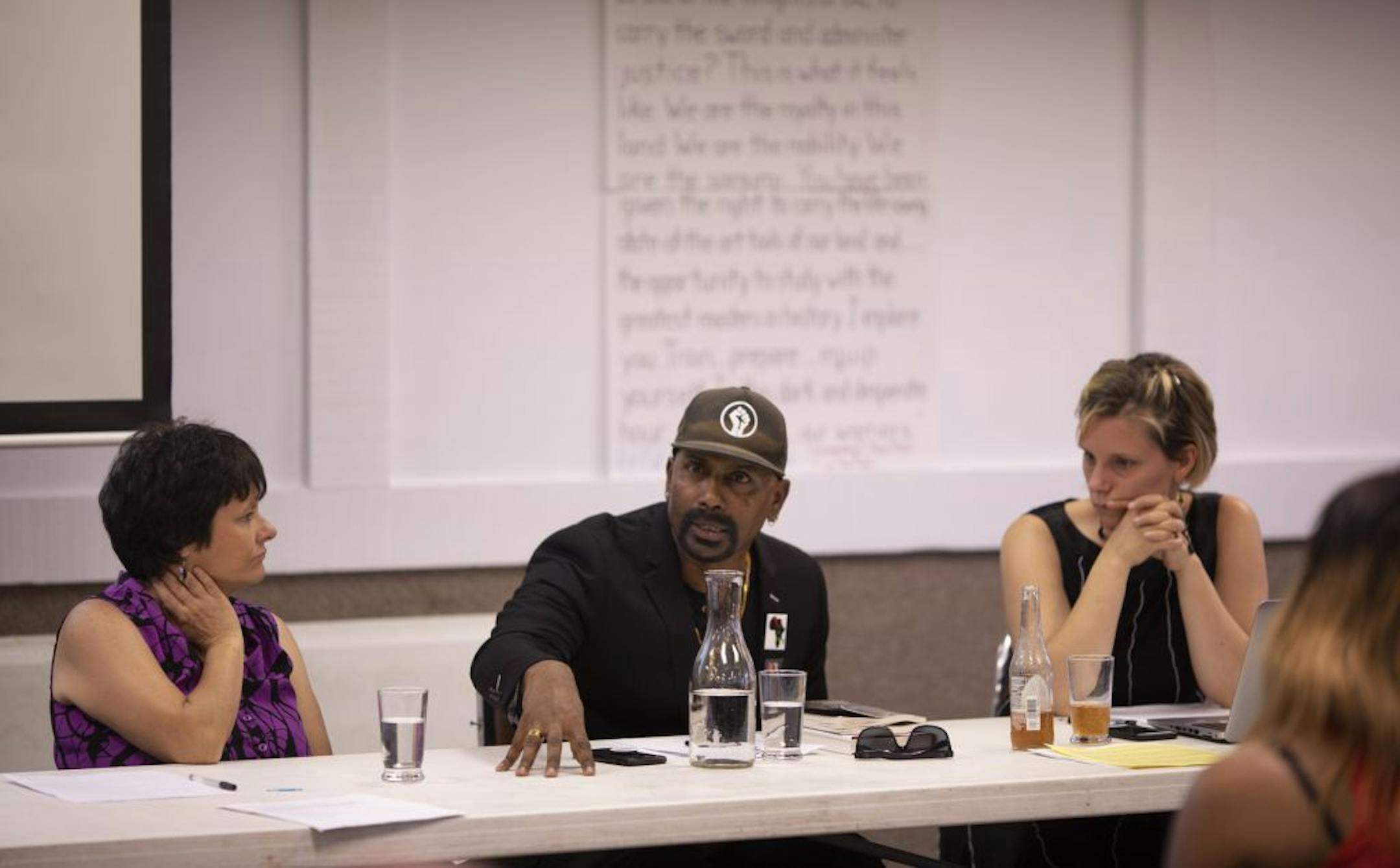 Panelists Sandi Simonson, left, and Rachael Rivard listened as Raj Sethuraju, a criminal justice professor, spoke about the origins of organized police work by the British in Ireland.