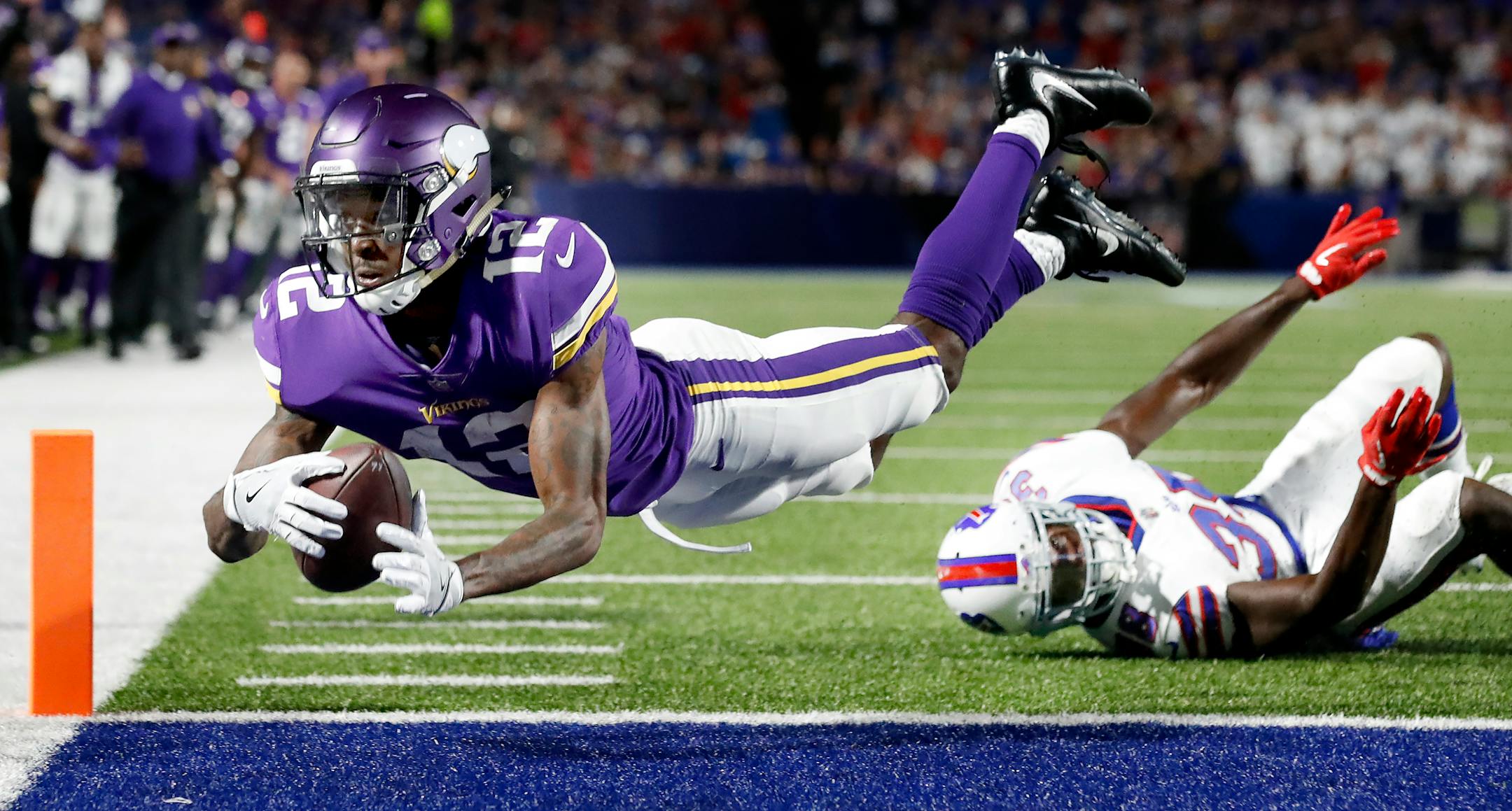 Rodney Adams (12) stretched out across the goal line to score a touchdown in the third quarter.