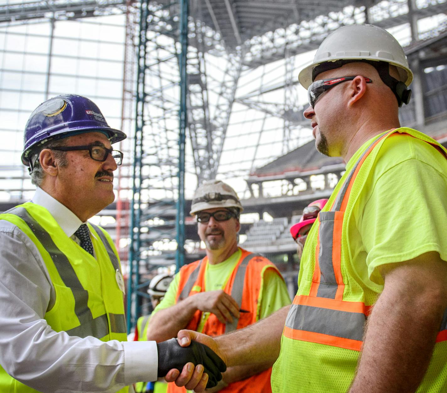 Vikings owner Zygi Wilf shook as many hands of stadium construction workers before he was was called to the stage. ] GLEN STUBBE * gstubbe@startribune.com Thursday September 16, 2015 A "topping out" ceremony for the new Minnesota Vikings stadium, marking the highest or last piece of steel placed on a building. Mark Wilf and Lt. Gov. Tina Smith were there. Heavy rain and lightening in the area made it unsafe to hoist the steel beam to the roof. Workers were treated to a free pork chop lunch. ORG