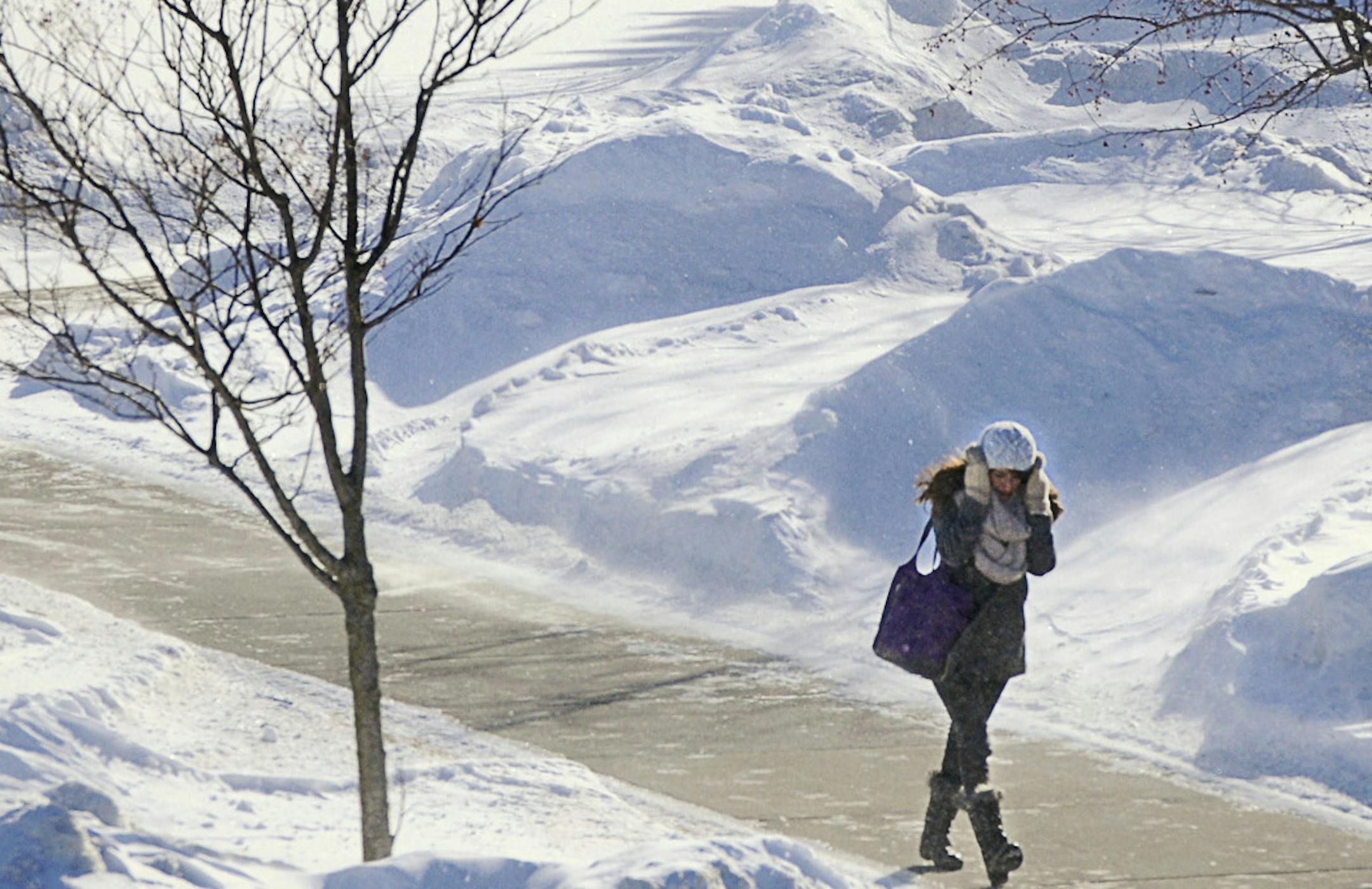 Students and faculty do their best to protect themselves from the wind and cold as they walk around at St. Cloud State University between classes on Wednesday, Jan. 22, 2014, in St. Cloud, Minn. (AP Photo/St. Cloud Times, Jason Wachter) NO SALES. ORG XMIT: MIN2014013016170281