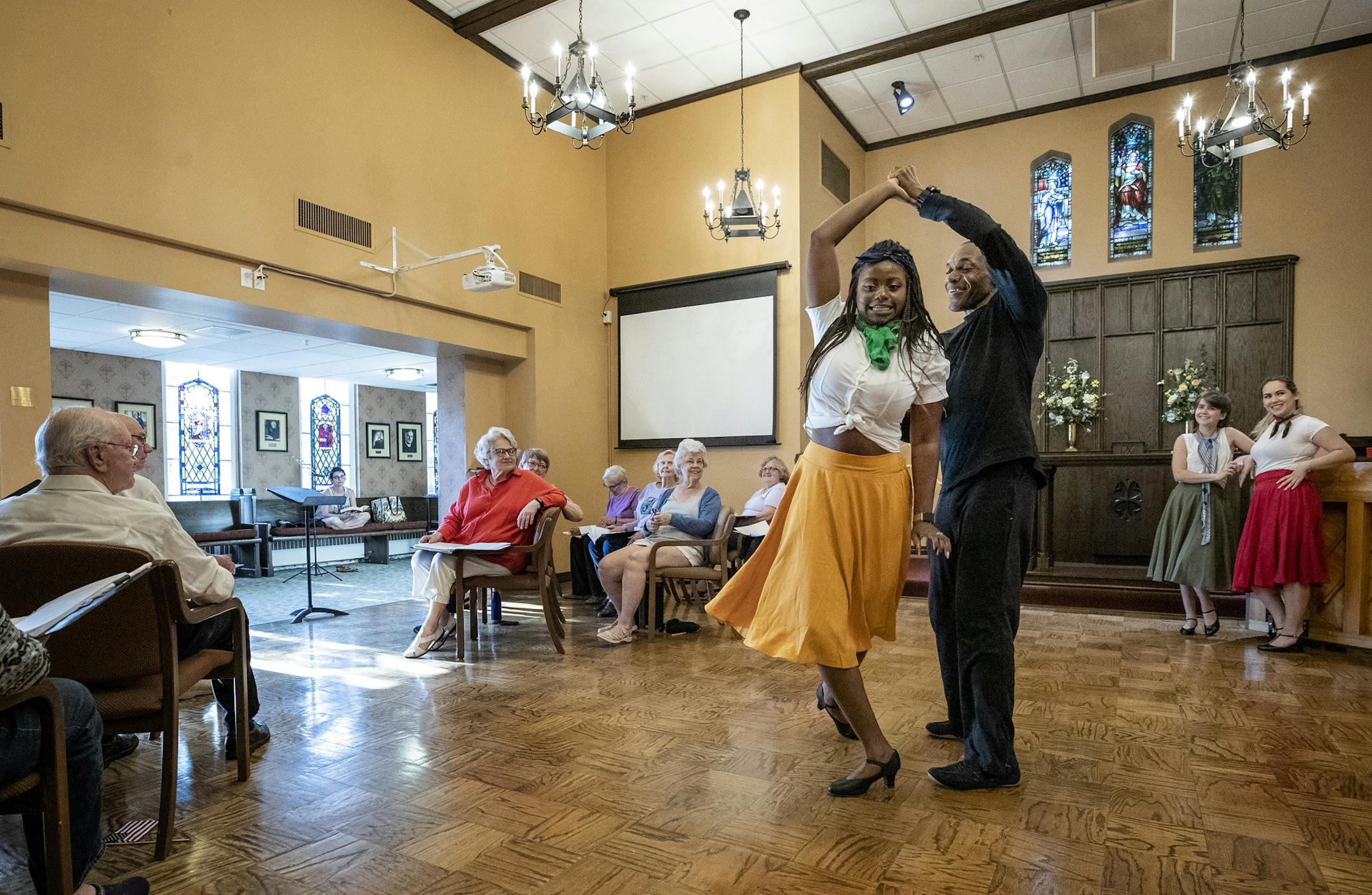 Amudalat Ajasa, 18, and Rande Tomas, 64, danced during a rehearsal for "Holding On: Unexpected Stories of World War II" at the Episcopal Homes in St. Paul.