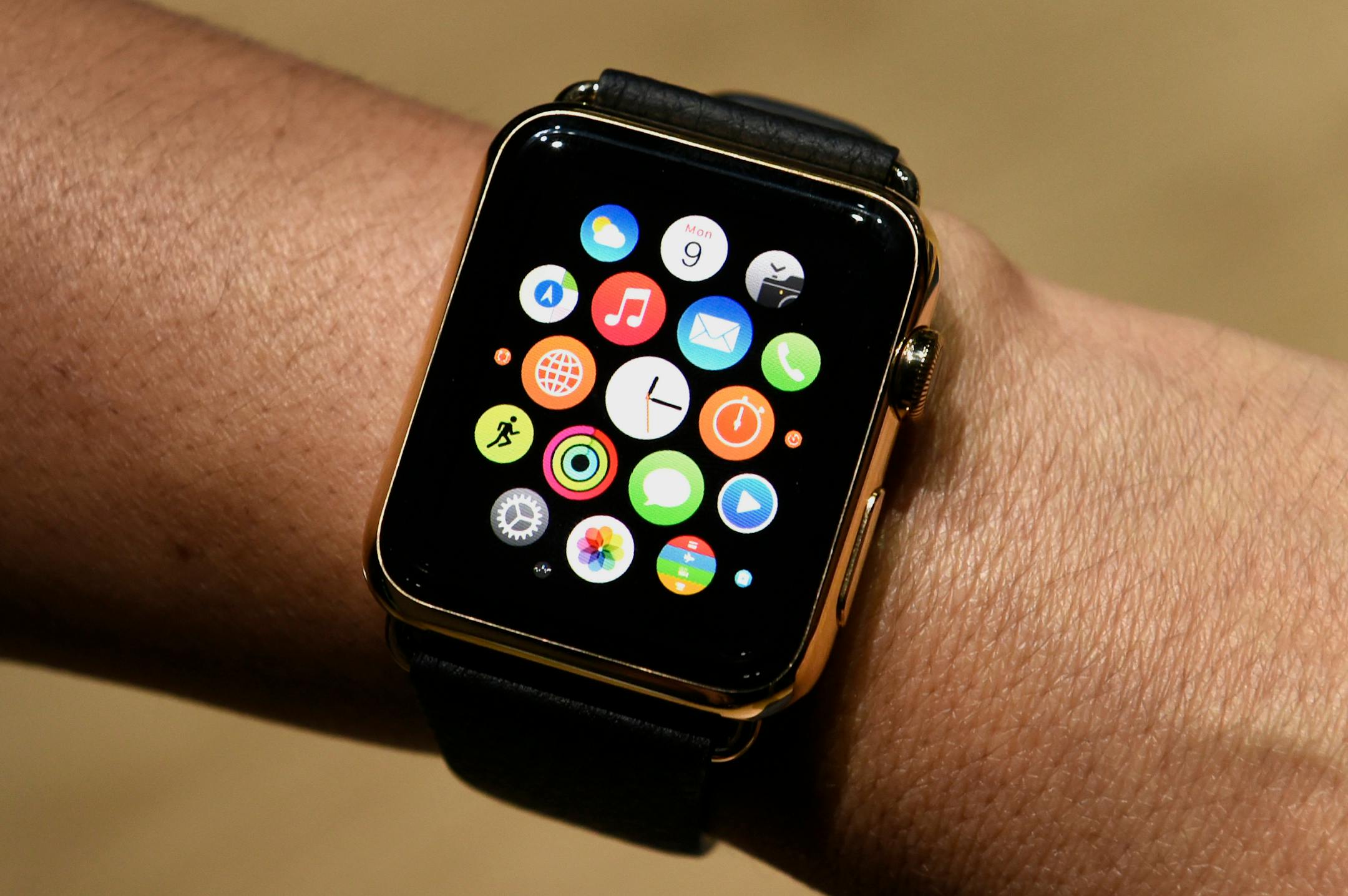 An attendee displays the Apple Watch Edition for a photograph during the Apple Inc. Spring Forward event in San Francisco, California, U.S., on Monday, March 9, 2015. Apple Inc. began showing off features and applications for its first new device in five years, a smartwatch designed to put information on peoples' wrists and break open the fledgling market for wearable technology. Photographer: David Paul Morris/Bloomberg