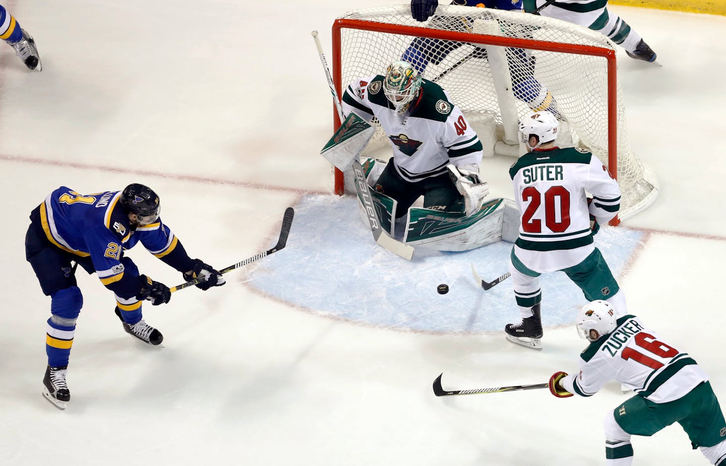 St. Louis Blues' Patrik Berglund shoots wide of Minnesota Wild goalie Devan Dubnyk (40), as Ryan Suter (20) and Jason Zucker (16) help defend .