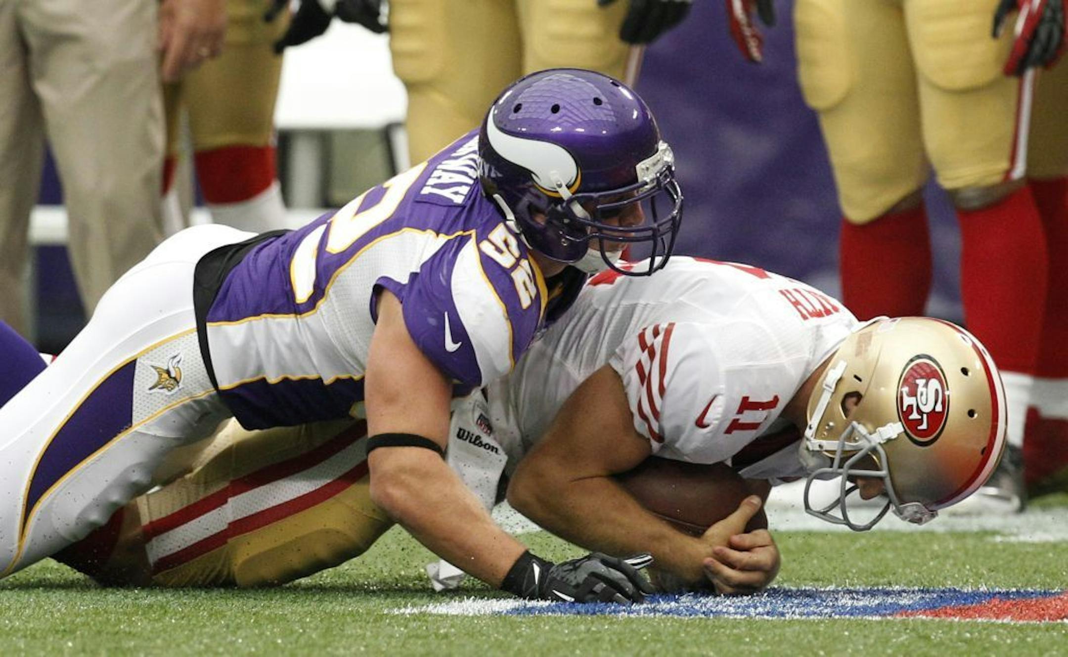 Minnesota Vikings outside linebacker Chad Greenway, left, sacks San Francisco 49ers quarterback Alex Smith during the first half of an NFL football game on Sunday, Sept. 23, 2012, in Minneapolis.