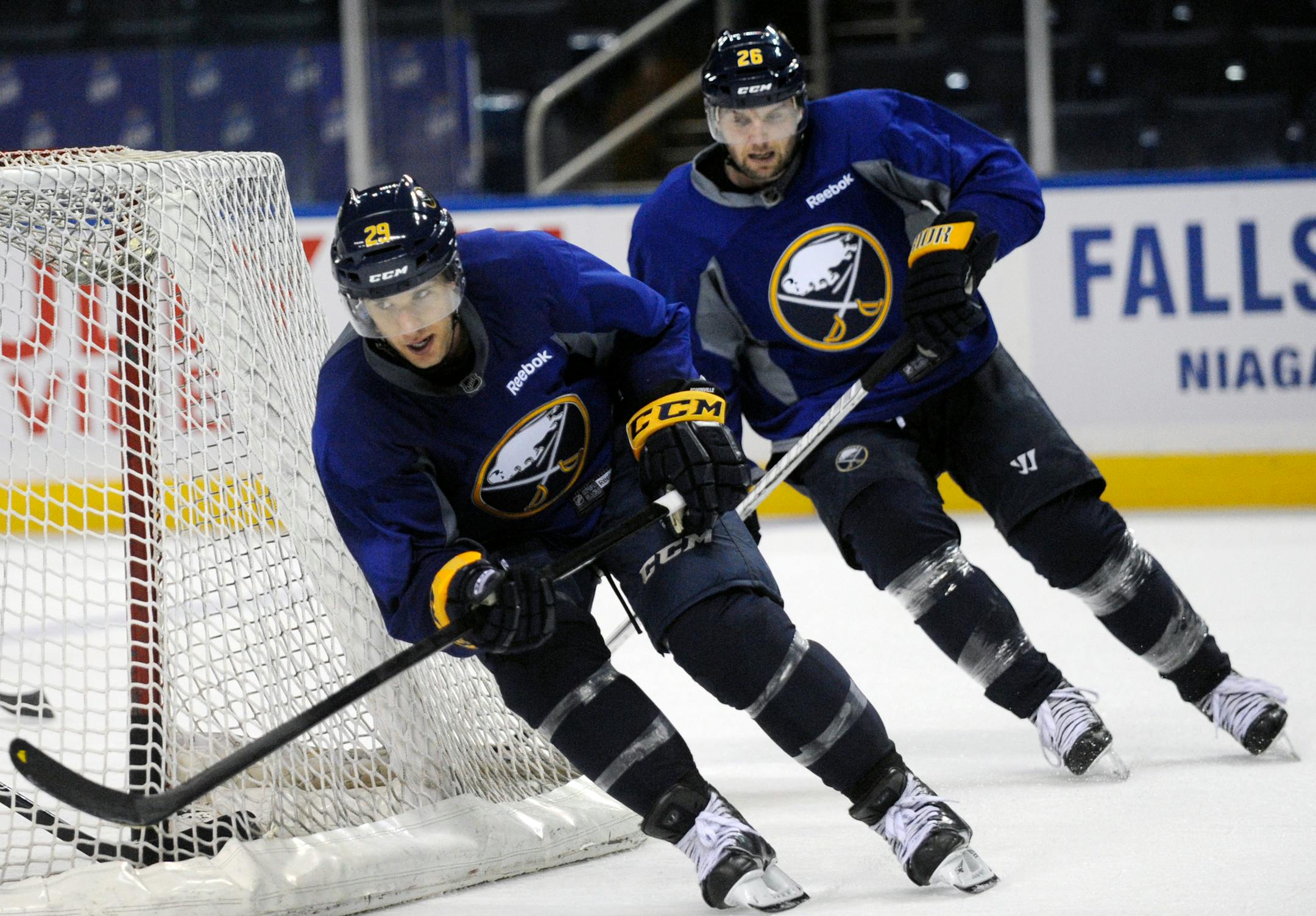 FILE - Jason Pominville and Thomas Vanek skate sprints around the net during the first day of the NHL hockey training camp in Buffalo, New York on Sunday, Jan. 13, 2013. Teammates then with the Sabres, POminville and Vanek are now in Minnesota and playing on the Wild's top line. (AP Photo/Gary Wiepert)
