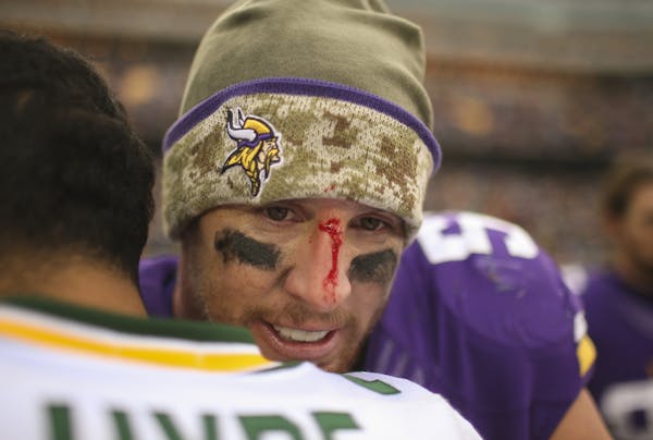A bloodied Vikings outside linebacker Chad Greenway had a hug for Green Bay free safety Micah Hyde after the game Sunday afternoon at TCF Bank Stadium