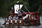 The Pirates of the Cow-ribbean milk carton boat competes in the final race of the afternoon Sunday at Lake Calhoun Park.