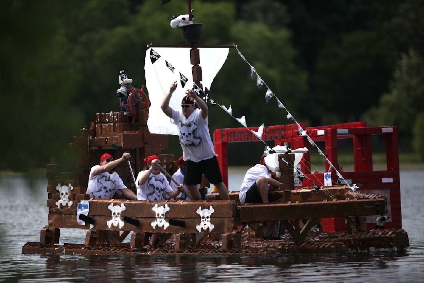 The Pirates of the Cow-ribbean milk carton boat competes in the final race of the afternoon Sunday at Lake Calhoun Park.