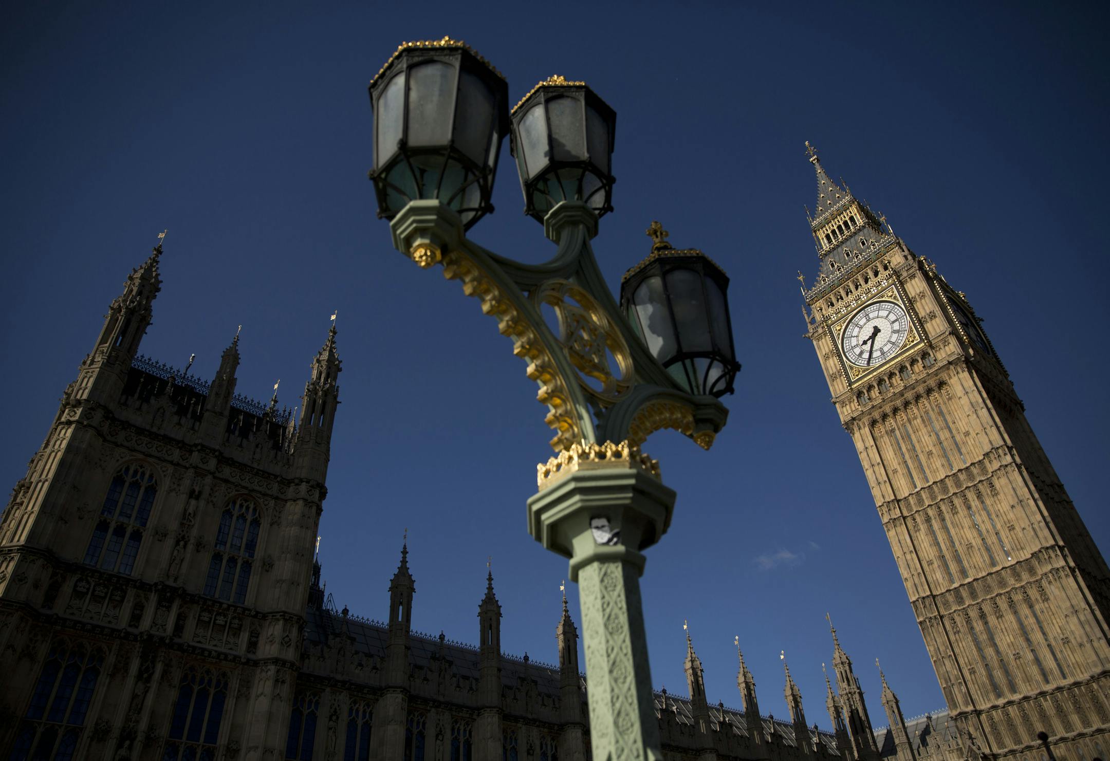 An exterior view shows the Houses of Parliament and Elizabeth Tower, which houses the Big Ben bell in London, Tuesday, April 26, 2016. Officials say the chimes of Britain's Big Ben bell will fall silent for several months during a three-year restoration of Parliament's crumbling clock tower. (AP Photo/Matt Dunham)