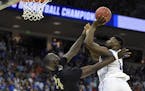 Duke's Zion Williamson, right, shoots over Central Florida's Tacko Fall during the second half of a second-round men's college basketball game in the 