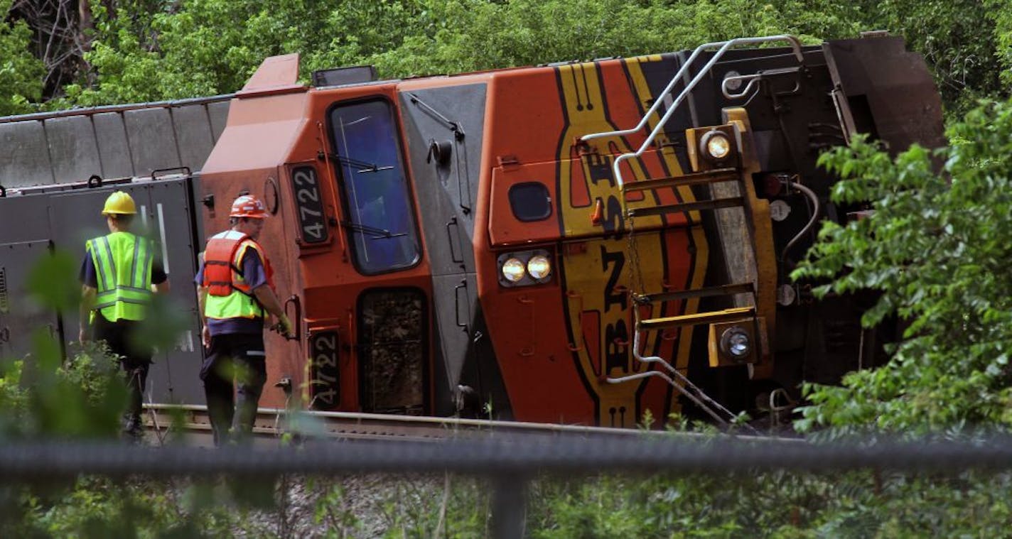 A Burlington Northern Santa Fe engine and cars blocked the tracks after derailing just over Rice Creek near Plaza Park in Fridley on Saturday 7/16/2011. A small portion of a bridge washed out due to high overnight rains in the area.