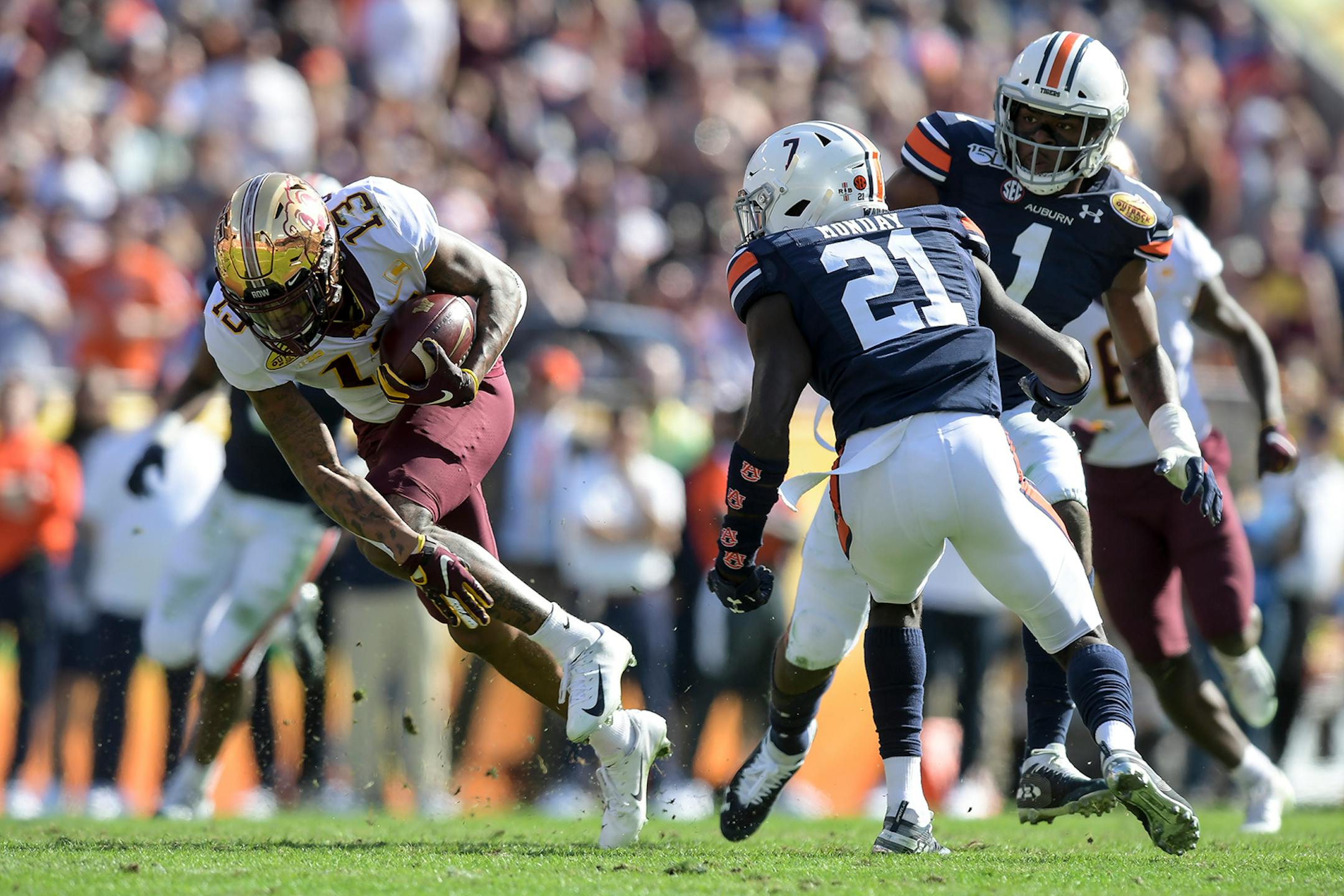 Minnesota Gophers wide receiver Rashod Bateman (13) ran the ball for a first down after a reception as Auburn Tigers defensive back Smoke Monday (21) eyed the. tackel in the second quarter.