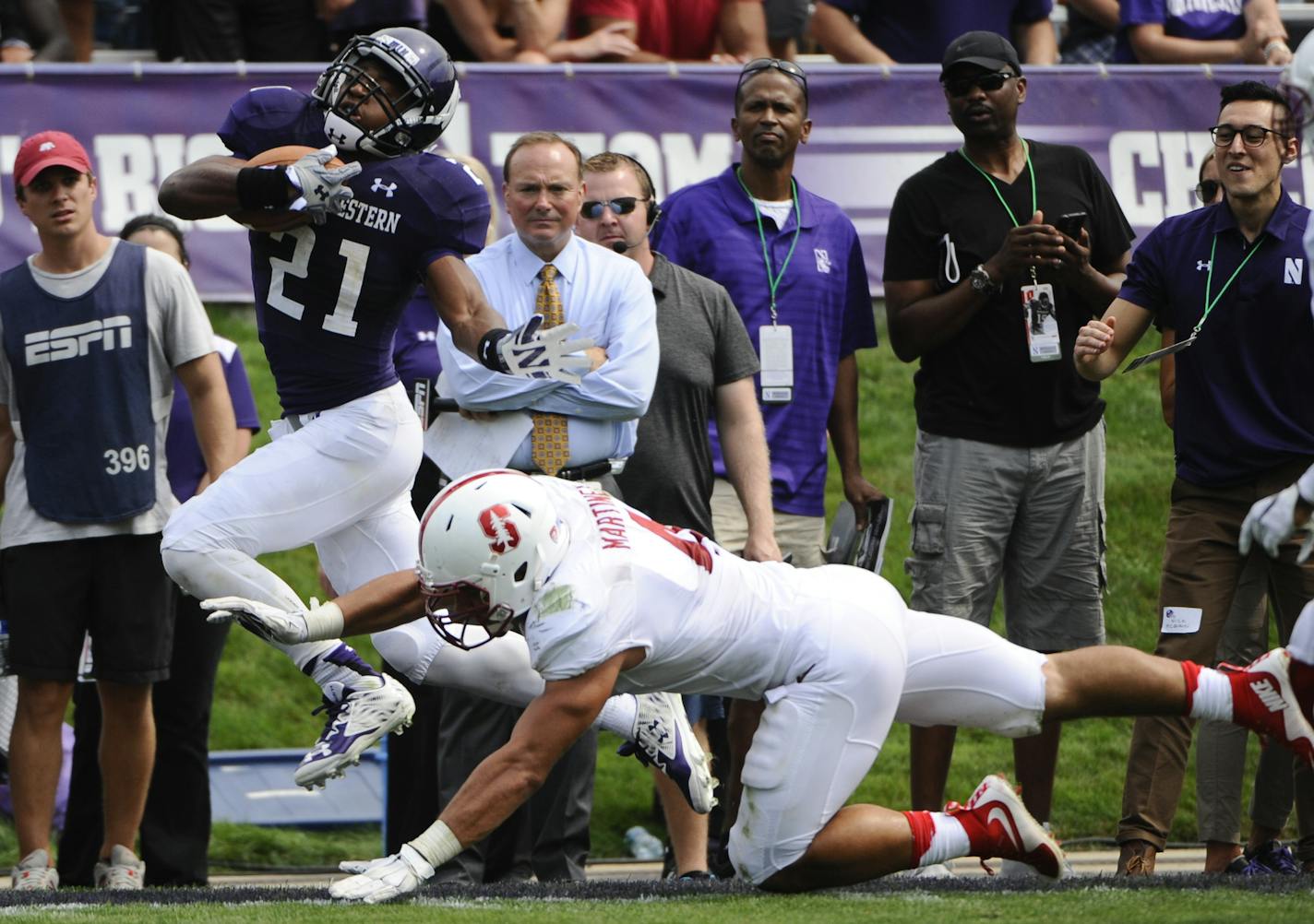 Northwestern running back Justin Jackson (21) is tackled by Stanford linebacker Blake Martinez (4) during an NCAA college football game in Evanston, Ill, Saturday, Sept. 5, 2015. (AP Photo/Matt Marton ORG XMIT: OTKMM101