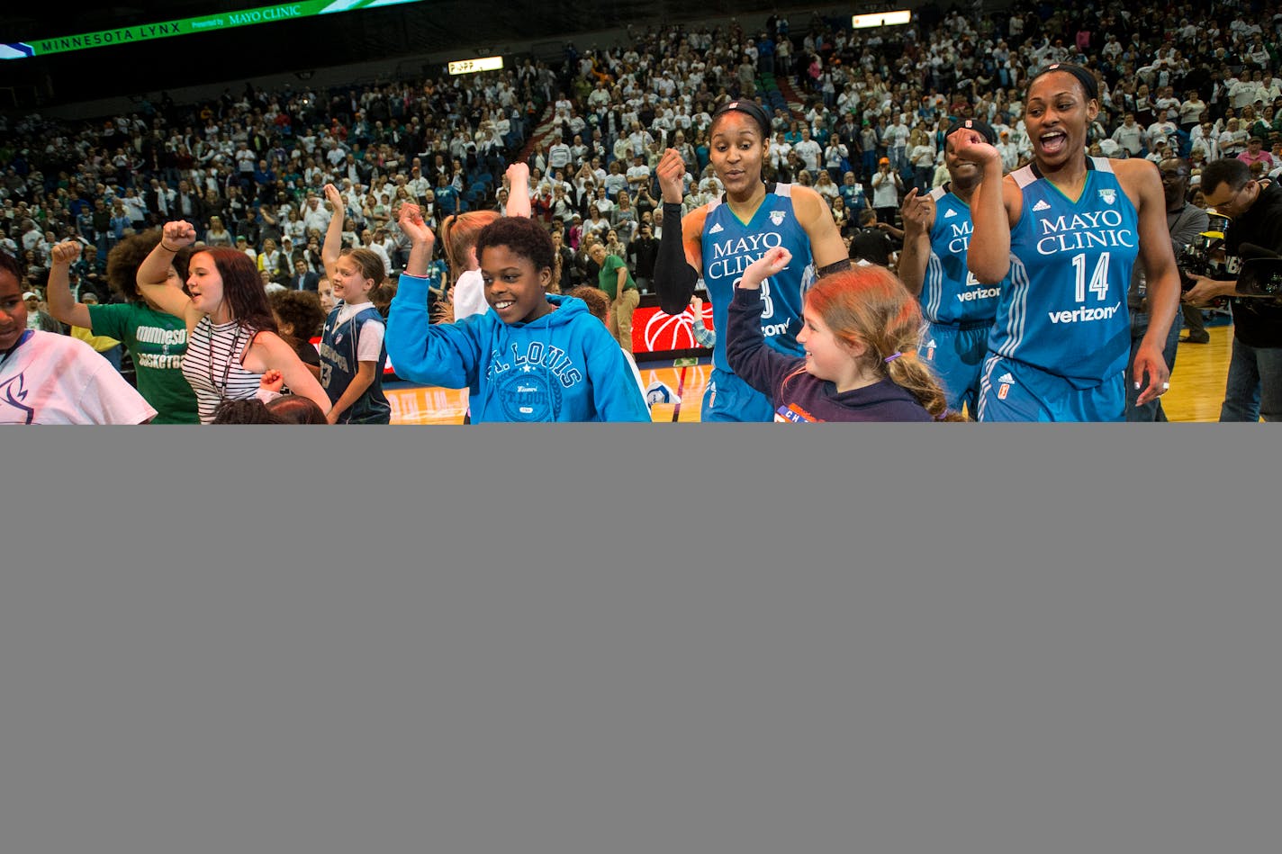 Lynx players, including forward Maya Moore (23) and forward Bashaara Graves (14), danced with young fans after their victory over the Phoenix Mercury Saturday night. Minnesota won 95-76.