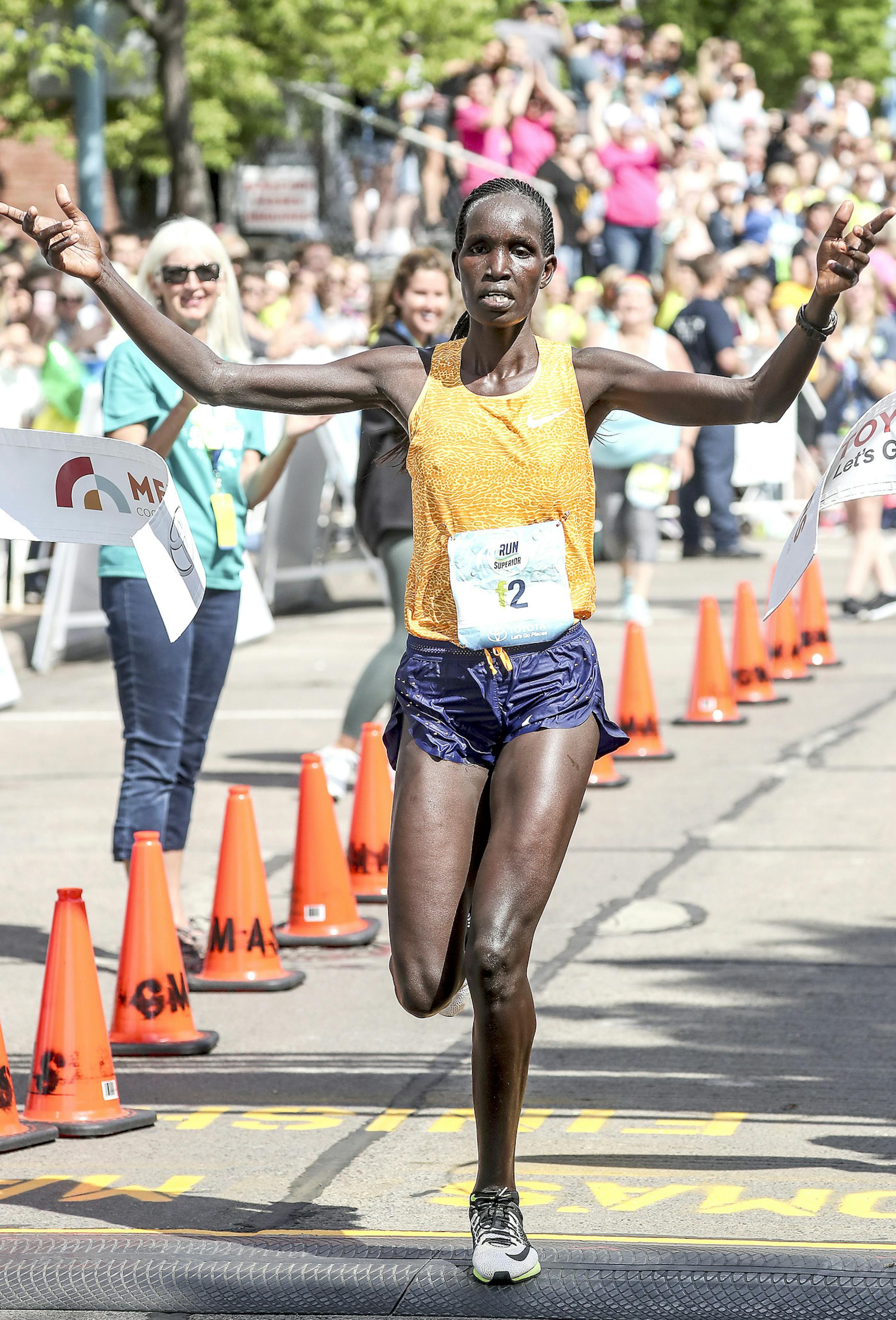 t051917 --- Clint Austin --- 091917.N.DNT.GRANDMAS.C45 --- Hellen Jepkurgat of Grand Prairie, Texas raises her hands in celebration at the finish line of Grandma's Marathon Saturday morning in Duluth. Jepkurgat was the winner of the women's race with a time of 2:32:09 (Clint Austin / caustin@duluthnews.com)