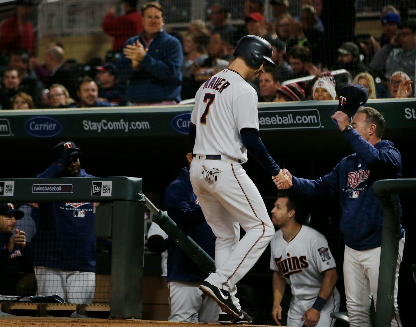 The Minnesota Twins' Joe Mauer is congratulated after breaking Harmon Killebrew's on-base record against Detroit on Tuesday.