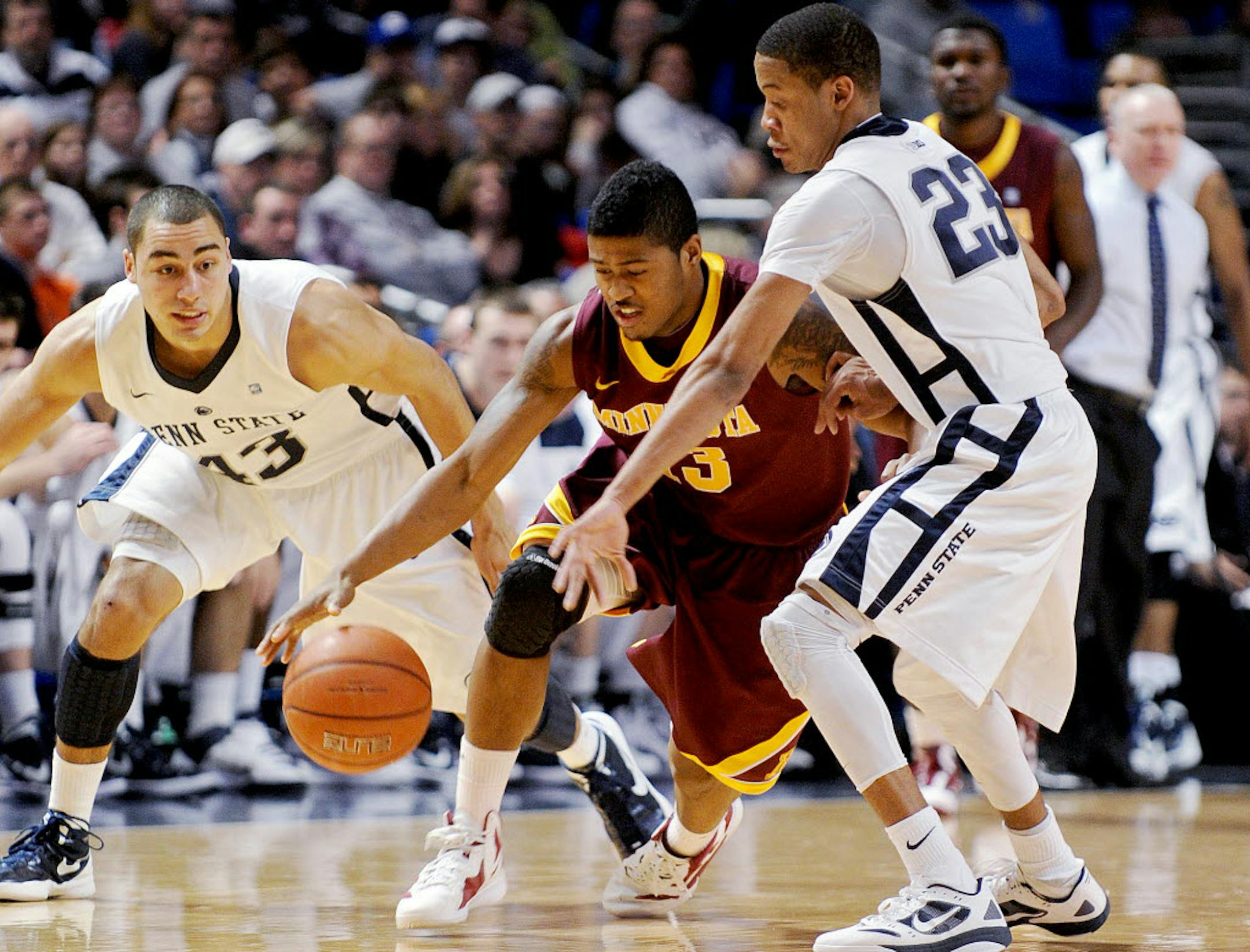 Minnesota's Maverick Ahanmisi dribbles around Penn State's Tim Frazier.