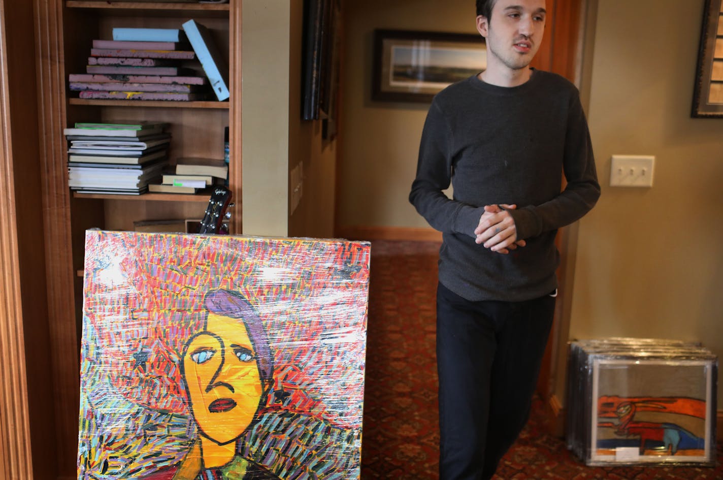 Artist Jimmy Reagan walks by one of his painting at the family home Wednesday, March 11, 2020, in Mendota Heights, MN. Reagan is influenced by Van Gogh, Picasso, Mid-Century artists and Expressionism.] DAVID JOLES • david.joles@startribune.com Jimmy Reagan, 26, is an acclaimed painter and artist, whose works fetch upwards of $1500 in galleries across the U.S. and around the world, including in places like Milan, Italy. He is also on the autism spectrum. Reagan has no formal art training but is t