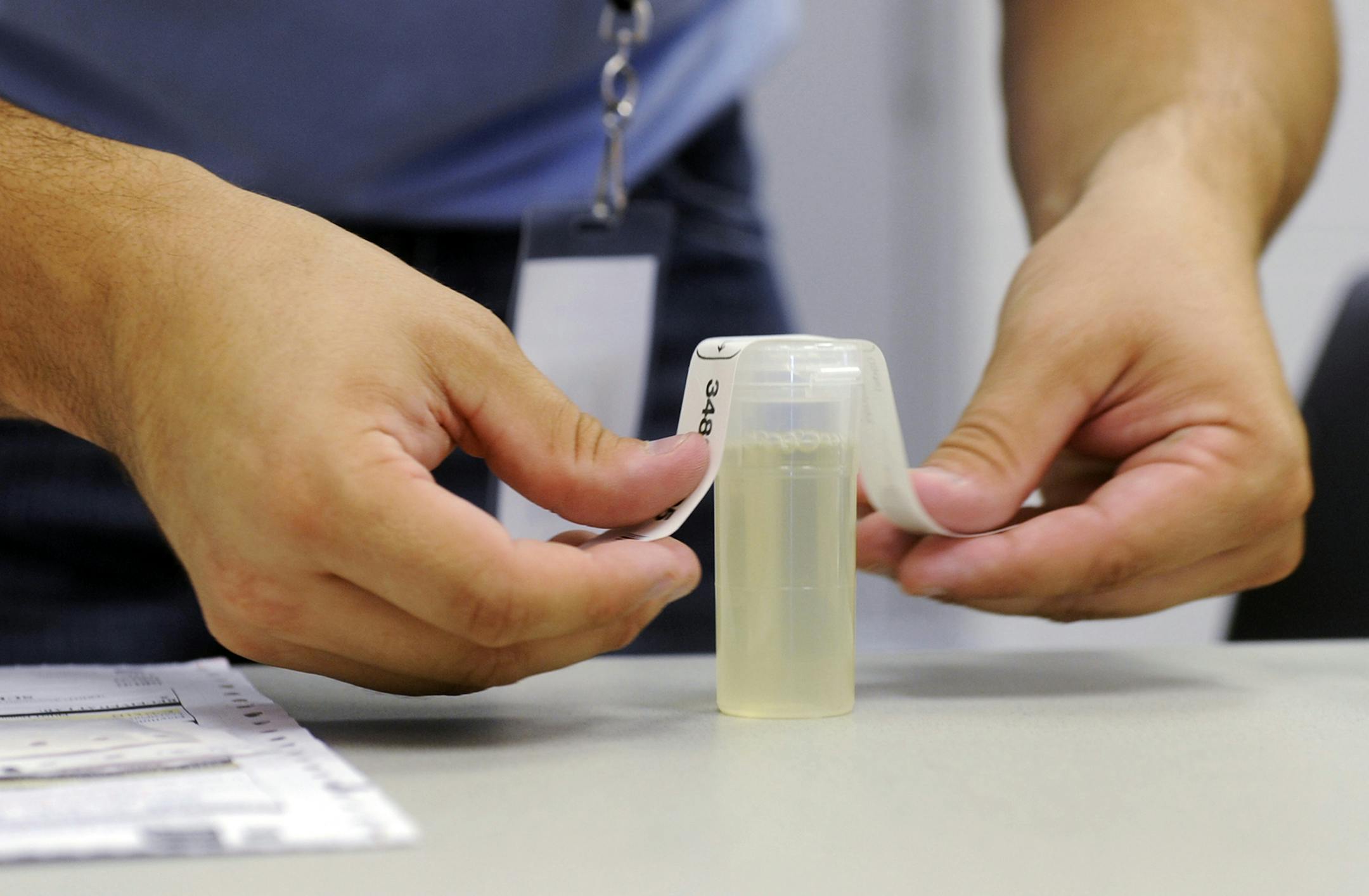Caleb Stoll, of Springfield, Mo.,with Employee Screening Services, lables a urine specimen vile Wednesday, Sept. 7, 2011, at Linn State Technical College in Linn, Mo. On Wednesday, the central Missouri school began conducting drug screens for all new students and any returning after an extended break in attendance. (AP Photo/Kelley McCall) ORG XMIT: JF104