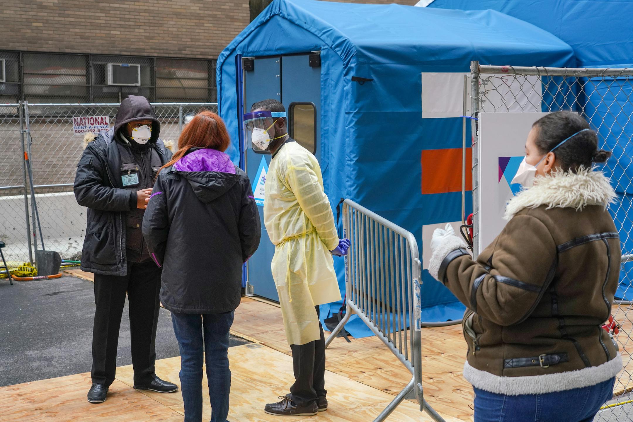 A woman speaks with medical staff before entering the temporary emergency room entrance for testing of the coronavirus at Mount Sinai Hospital West in New York, Friday, April 3, 2020. The coronavirus is taking lives at a devastating pace in New York, Gov. Andrew Cuomo said, with deaths nearly doubling in just three days, from 1,550 on Tuesday to 2,935 on Friday. (Chang W. Lee/The New York Times)
