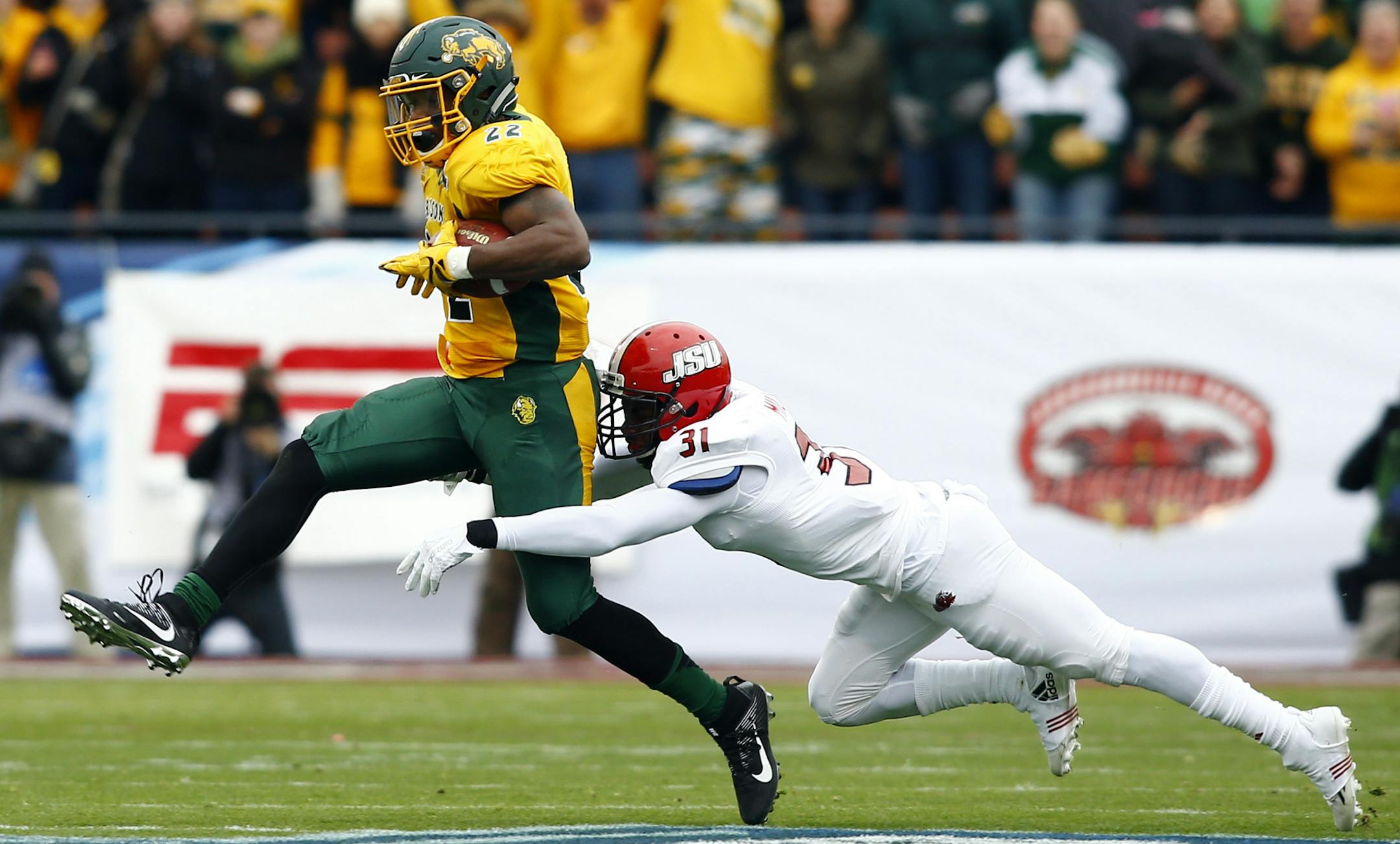 North Dakota State running back King Frazier (22) carries the ball as Jacksonville State safety DeBarriaus Miller (31) tries to make the tackle during the first half of the FCS championship NCAA college football game, Saturday, Jan. 9, 2016, in Frisco, Texas. (AP Photo/Mike Stone) ORG XMIT: TXMS104