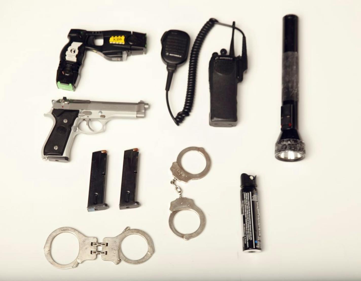 Minneapolis Sgt. Steven C. Bantle showed off the thirty pounds of gear a police officer has to don including an eye-irritant spray, handcuffs, taser, a semi-automatic pistol with three magazines of 15 bullets + 1 in the chamber. a radio, a flashlight, and two pair of handcuffs.